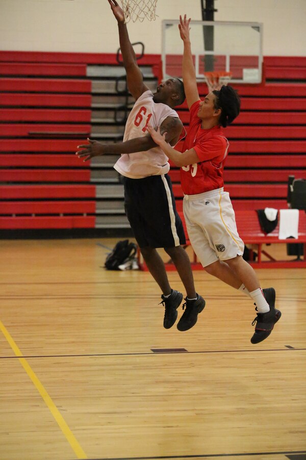 Aaron Bonner, Marine Corps Systems Command team member, attempts to score against the Marine Corps Embassy Security Guard team at the Barber Physical Activities Center on Feb. 19, 2014. MCSC won the game 68-27. 