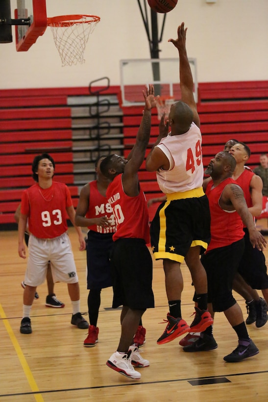 Brian Gardner, Marine Corps Systems Command team member, makes a shot against the Marine Corps Embassy Security Guard team at the Barber Physical Activities Center on Feb. 19, 2014. MCSC won the game 68-27, bringing their seasonal standing to 7-1.