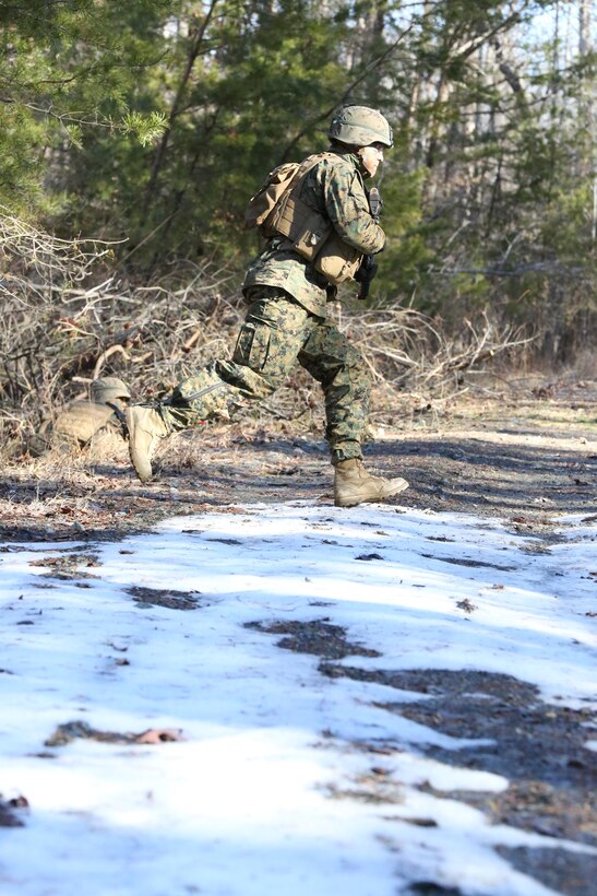 A Marine runs across a road during a field exercise at The Basic School on Feb. 24, 2014. During the exercise, Alpha Co. students were able take what they’d learned in the classroom and apply it in the field. 