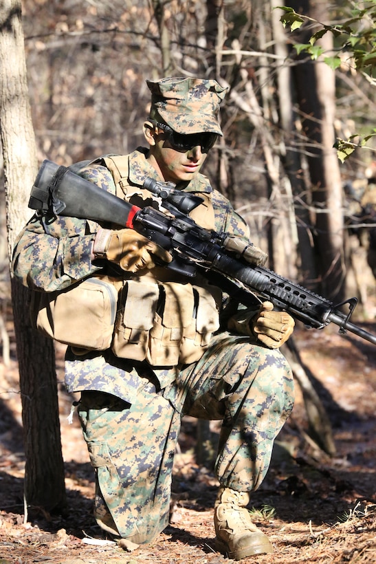 Second Lt. Miles Stebbins, right flanker for a security patrol, moves through the woods during a patrol exercise at The Basic School on Feb. 24, 2014. The field exercise was the second of the course and gave the Marines an opportunity to practice what they have been taught about patrols.