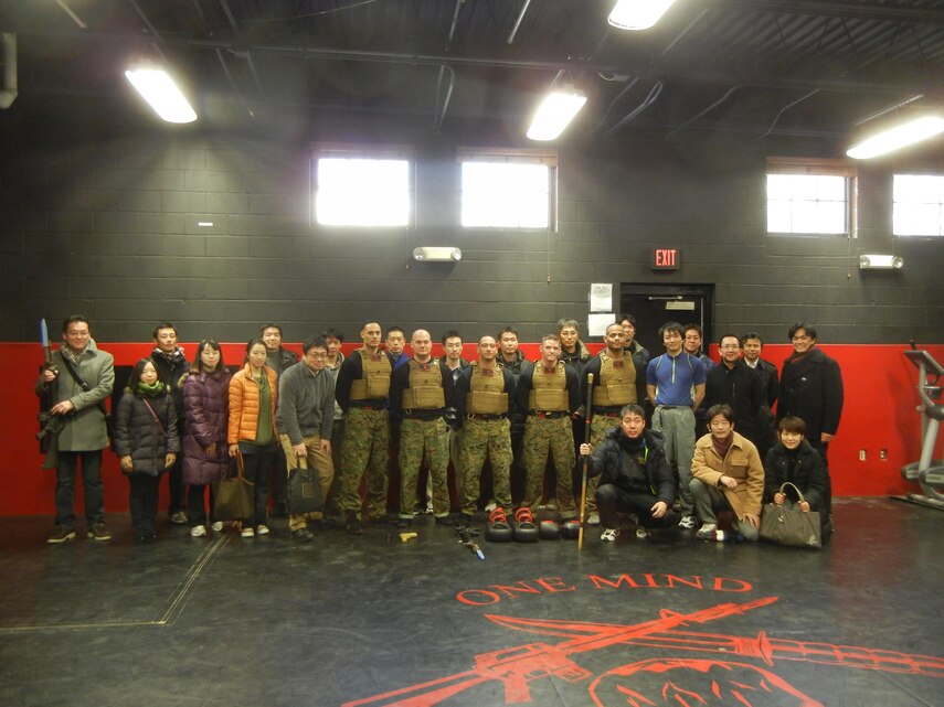 A group of Japanese Ministry of Defense officials poses with the Marine Corps Martial Arts Program instructors who gave them demonstrations of hand-to-hand combat at the Martial Arts Center for Excellence on Feb. 11, 2014, during the group’s tour of The Basic School. The visit was part of a two-week tour of agencies and offices of the American Department of Defense hosted by the Center for Strategic and International Studies. 