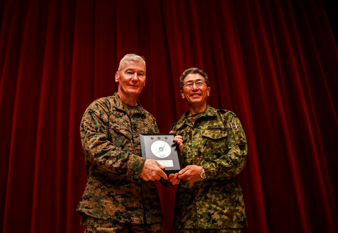 Japanese Maj. Gen. Hiroaki Kawamoto, right, deputy chief of staff, Western Army Headquarters, Japan Ground Self-Defense Force, presents U.S. Marine Lt. Gen. John A. Toolan, commanding general, I Marine Expeditionary Force, with a gift at the closing ceremony for Exercise Iron Fist 2014 aboard Camp Pendleton, Calif., Feb. 24, 2014. Iron Fist is an amphibious exercise that brings together Marines and sailors from the 15th MEU, other I Marine Expeditionary Force units, and soldiers from the JGSDF, to promote military interoperability and hone individual and small-unit skills through challenging, complex and realistic training. (U.S. Marine Corps photo by Cpl. Emmanuel Ramos/Released)