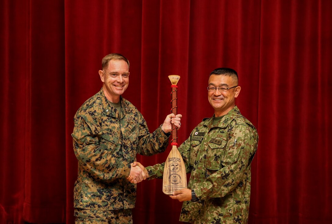 U.S. Marine Lt. Col. John R. O’Neal, left, commanding officer, 15th Marine Expeditionary Unit, presents Col. Matushi Kunii, commanding officer, Western Army Infantry Regiment, Japan Ground Self-Defense Force, with a gift at the closing ceremony for Exercise Iron Fist 2014 aboard Camp Pendleton, Calif., Feb. 24, 2014. Iron Fist is an amphibious exercise that brings together Marines and sailors from the 15th MEU, other I Marine Expeditionary Force units, and soldiers from the JGSDF, to promote military interoperability and hone individual and small-unit skills through challenging, complex and realistic training. (U.S. Marine Corps photo by Cpl. Emmanuel Ramos/Released)