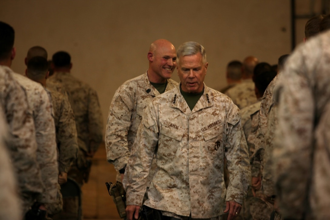 General James F. Amos, commandant of the Marine Corps, and Sgt. Maj. Micheal P. Barrett, sergeant major of the Marine Corps, leave a town hall meeting after speaking with Marines and sailors aboard Camp Leatherneck, Helmand province, Afghanistan, Feb. 18, 2014. General Amos and Sgt. Maj. Barrett held the meeting to speak about the peacetime Marine Corps Force, the "reawakening" of the Corps and to address concerns of the Marines and sailors in Regional Command (Southwest).
