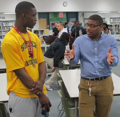 Justin Colar, civil engineer, Huntsville Center's Engineering Directorate, mentors a student during the STEM outreach event at Butler High School Feb. 20.   