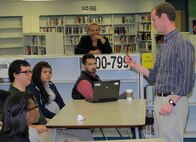 John Nevels, structural engineer, Huntsville Center's Engineering Directorate, mentors a student during the STEM outreach event at Butler High School Feb. 20.              