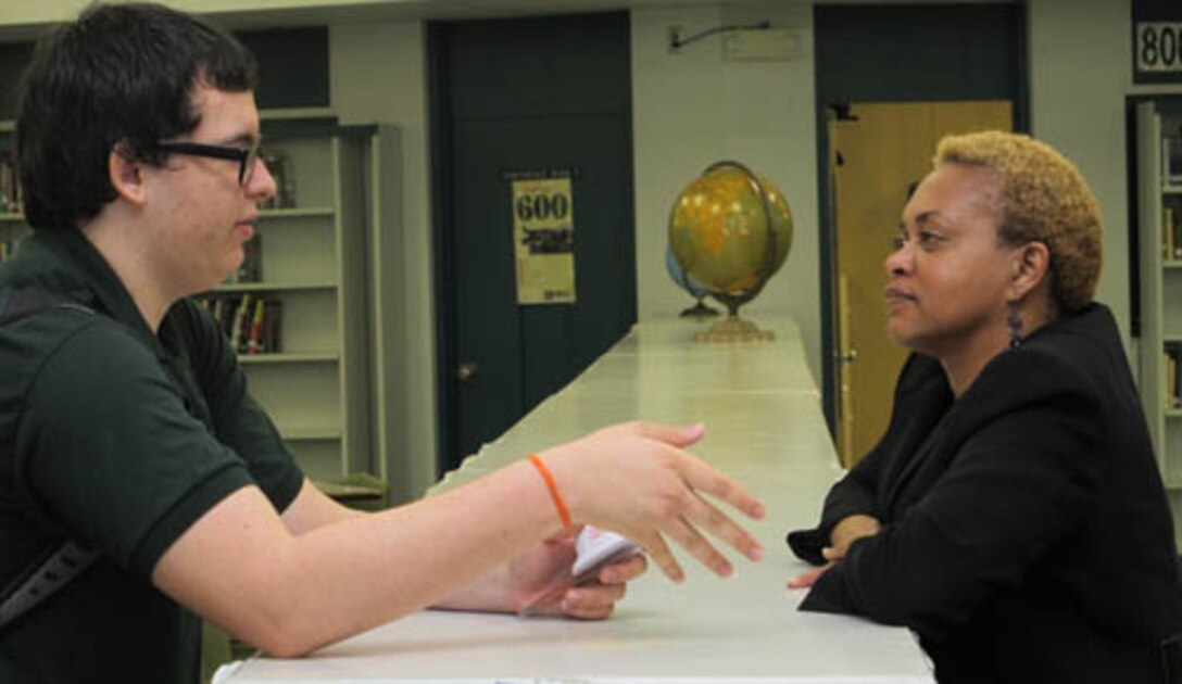 April Rafael-Adams, mechanical engineer, Huntsville Center's Engineering Directorate mentors a student during the STEM outreach event held at Butler High School Feb. 20.