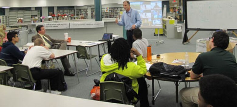 Huntsville Center engineers Patrick Haas, Chemical Demilitarization Directorate (standing), Chris Cochrane, Ordnance and Explosives Directorate (far left) and Wesley Turner, Installation Support and Programs Management Directorate  mentor students during the STEM outreach event at Butler High School Feb. 20.