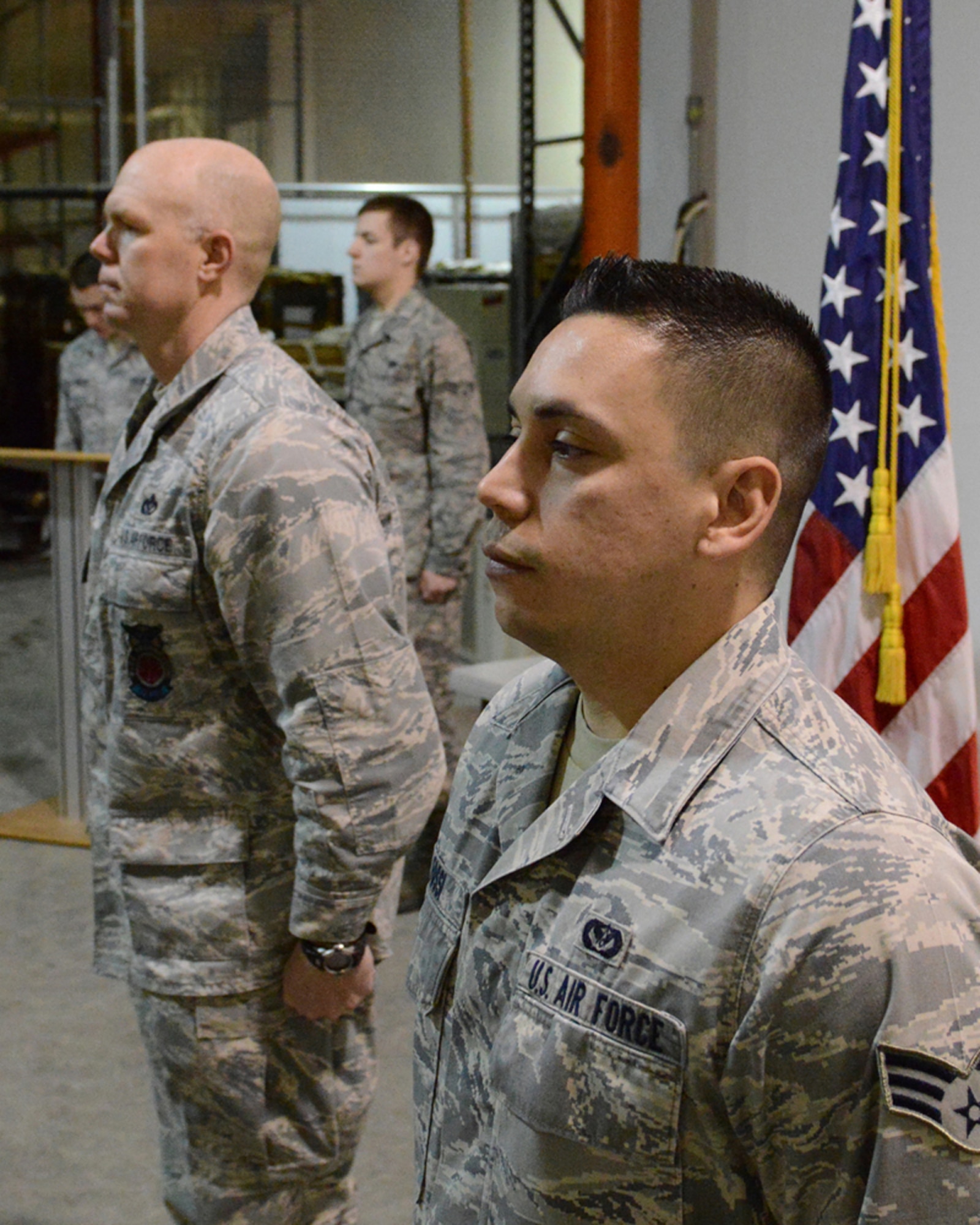 140219-F-IY975-002: JOINT BASE ELMENDORF-RICHARDSON, Alaska – Senior Airman Andres Fossi, 673d Civil Engineer Squadron engineer technician (right), stands ready to receive the Defense Meritorious Service Medal, presented by Air Force Col. Anthony Ramage, 673d Civil Engineer Group commander, Feb. 19 on Joint Base Elmendorf-Richardson. Fossi was one of three civil engineers to be recognized for exceptionally meritorious service during recent deployments to Afghanistan. (U.S. Air Force photo/Staff Sgt. Blake Mize)