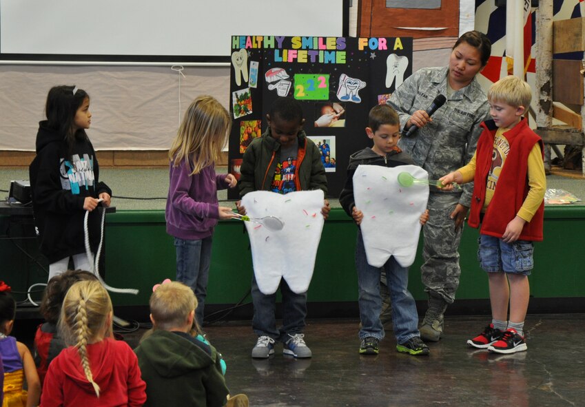 Senior Airman Jennifer McLear, 9th Aerospace Medicine Squadron dental assistant, instructs students of Lone Tree Elementary School how to properly brush teeth at Beale Air Force Base, Calif., Feb. 20, 2014. According to the American Dental Association developing good oral hygiene habits at an early age promotes a lifestyle of healthy teeth and gums. (U.S. Air Force photo by Staff Sgt. Robert M. Trujillo/Released)