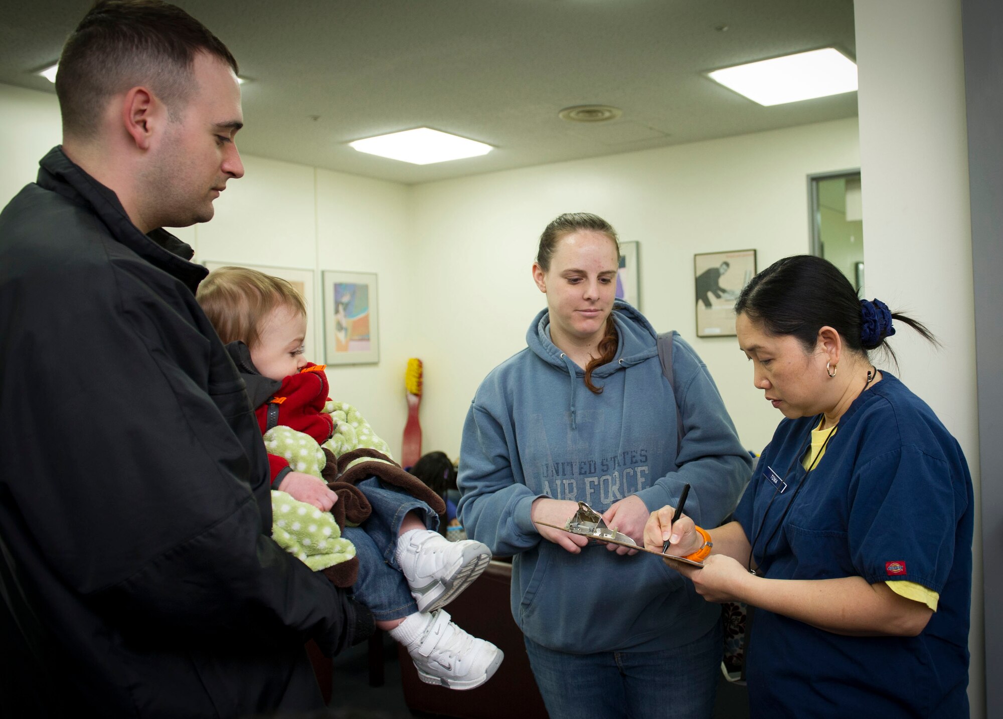 YOKOTA AIR BASE, Japan – Yokota families register their children during the Little Teeth-Big Smiles event at Yokota Air Base, Japan, Feb. 25, 2014. Every year the 374 Dental Squadron hosts a walk-in clinic for children, including dental examinations, cleanings and education services as part of National Children's Dental Health Month. (U.S. Air Force photo by Staff Sgt. Andrea Salazar/Released)
