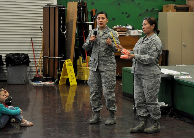 Staff Sgt. Rosario Warren (left) and Senior Airman Jennifer McLear, 9th Aerospace Medicine Squadron dental assistants, demonstrate how to properly brush teeth to students of Lone Tree Elementary School at Beale Air Force Base, Calif., Feb. 20, 2014. February is National Children’s Dental Health Month. (U.S. Air Force photo by Staff Sgt. Robert M. Trujillo/Released)