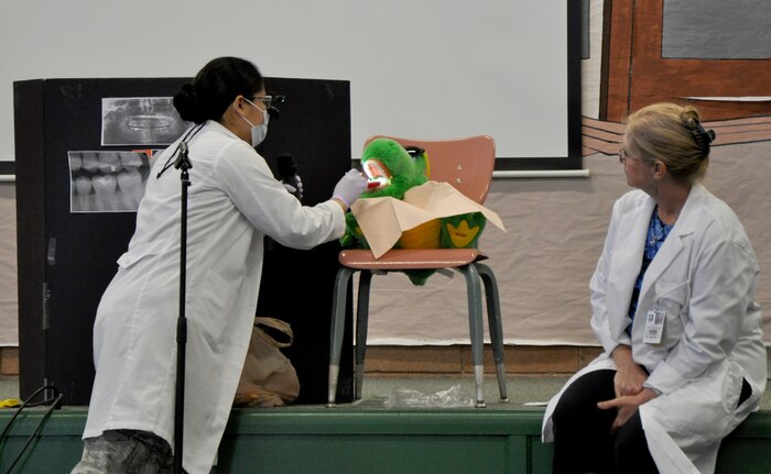 Capt. (Dr.) Kimberly Quilao, 9th Aerospace Medicine Squadron dentist, demonstrates a dental examination to students of Lone Tree Elementary School at Beale Air Force Base, Calif., Feb. 20, 2014. Quilao also showed students X-rays and how dentists use them to identify cavities. (U.S. Air Force photo by Staff Sgt. Robert M. Trujillo/Released)
