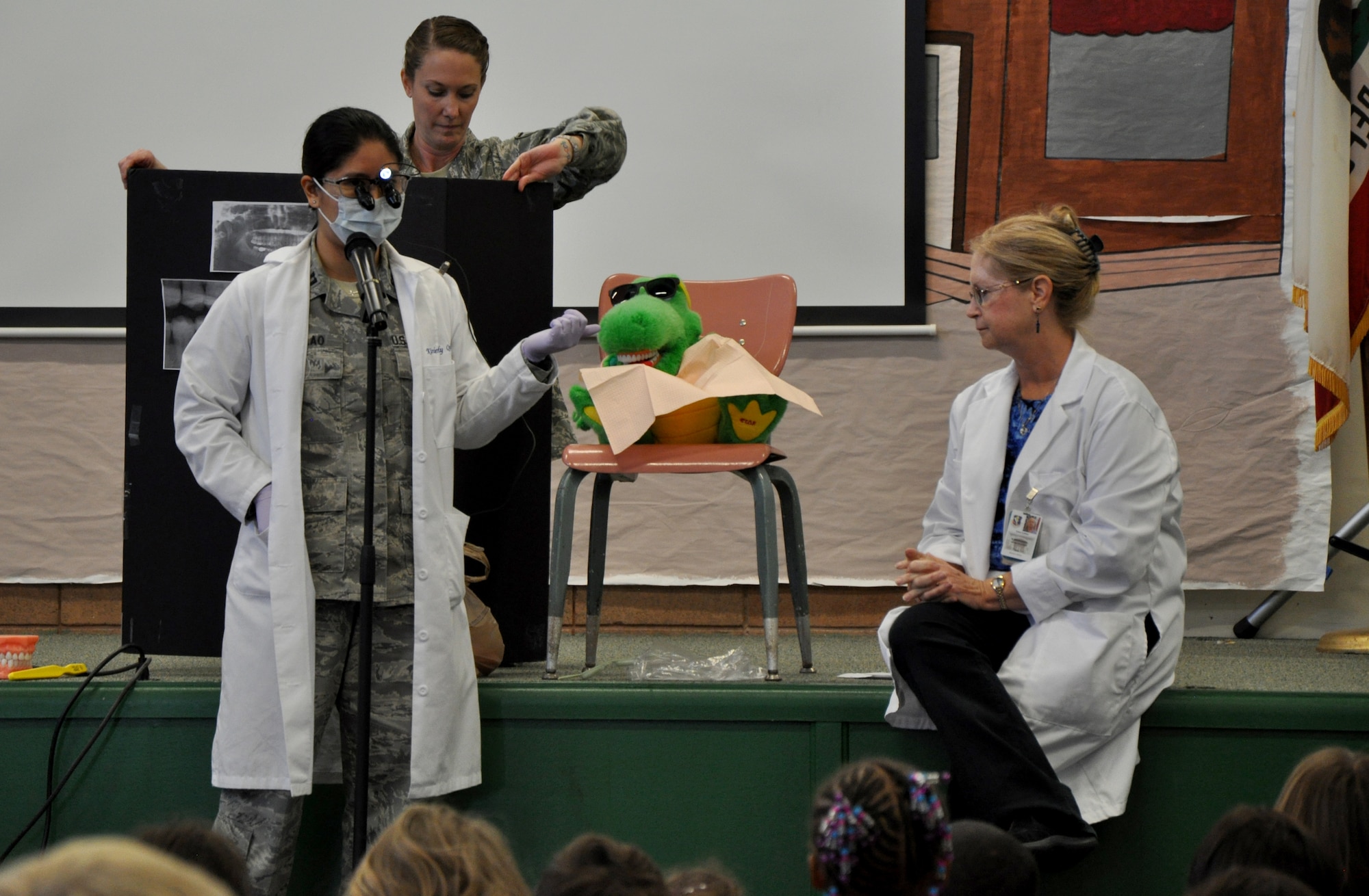 Capt. (Dr.) Kimberly Quilao, 9th Aerospace Medicine Squadron dentist, speaks to students of Lone Tree Elementary School on the importance of dental care at Beale Air Force Base, Calif., Feb. 20, 2014. Quilao also informed students of the different types of foods that lead to tooth decay such as sugary candy. (U.S. Air Force photo by Staff Sgt. Robert M. Trujillo/Released)