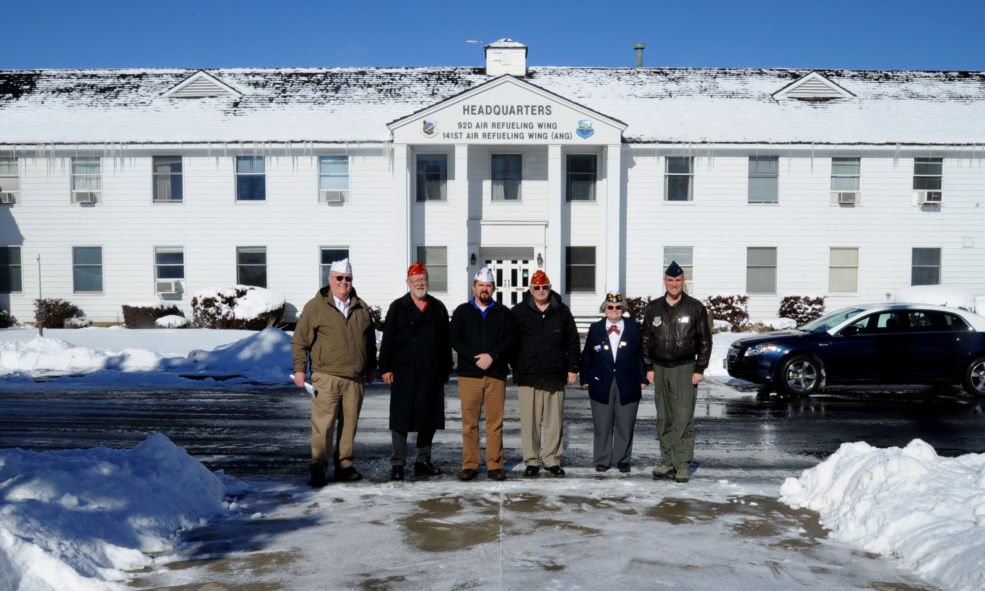 Col. Brian Newberry, 92nd Air Refueling Wing commander, poses for a photo with members of the American Legion in front of the headquarters building at Fairchild Air Force Base, Wash., Feb. 25, 2014.  The American Legion is an organization that promotes veterans' interests.  (U.S. Air Force photo by Airman 1st Class Sam Fogleman/Released)