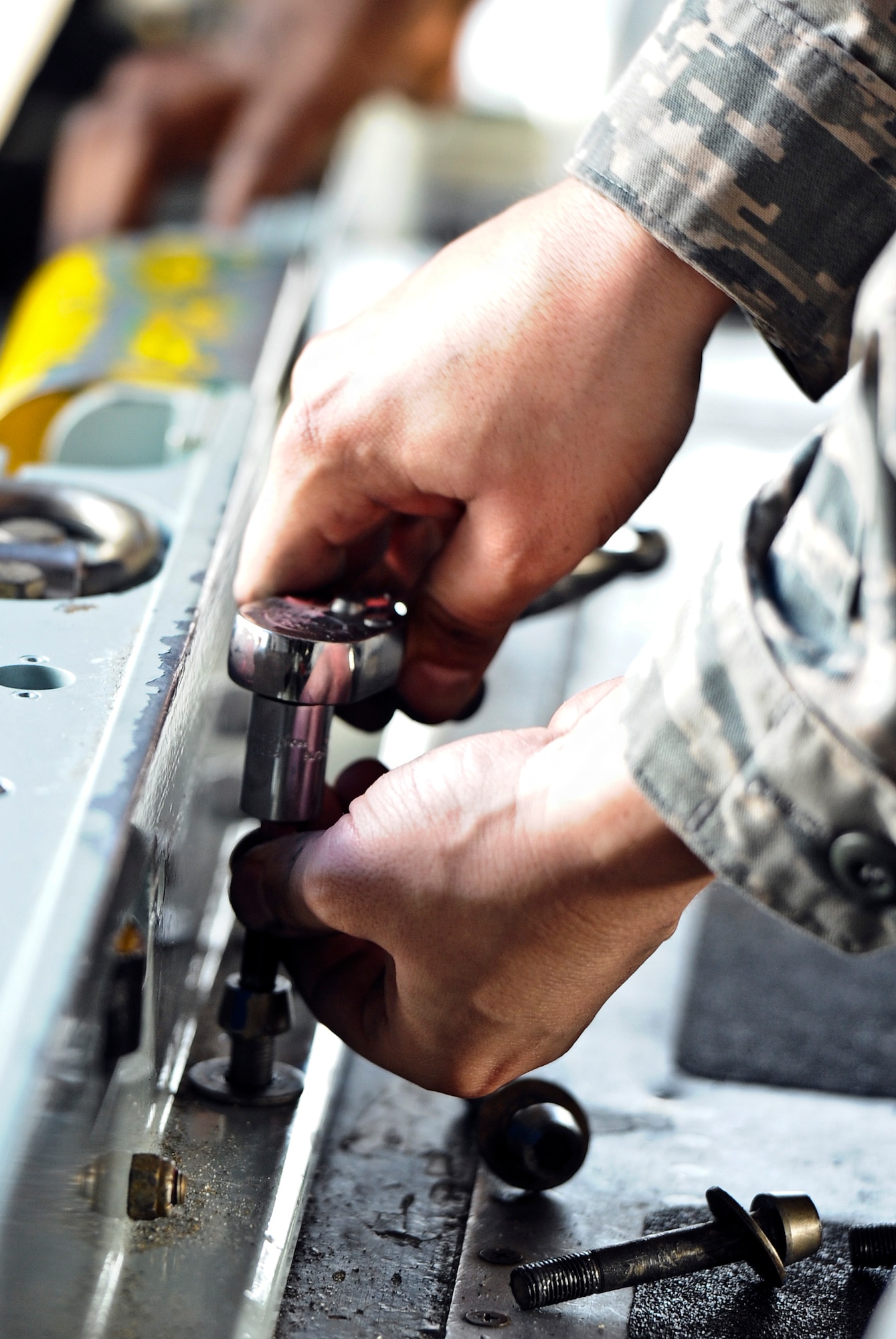 An Airman ratchets a screw in place on a MC-130H Combat Talon II on the flightline at Hurlburt Field, Fla., Feb. 19, 2014. (U.S. Air Force photo/Senior Airman Michelle Vickers)