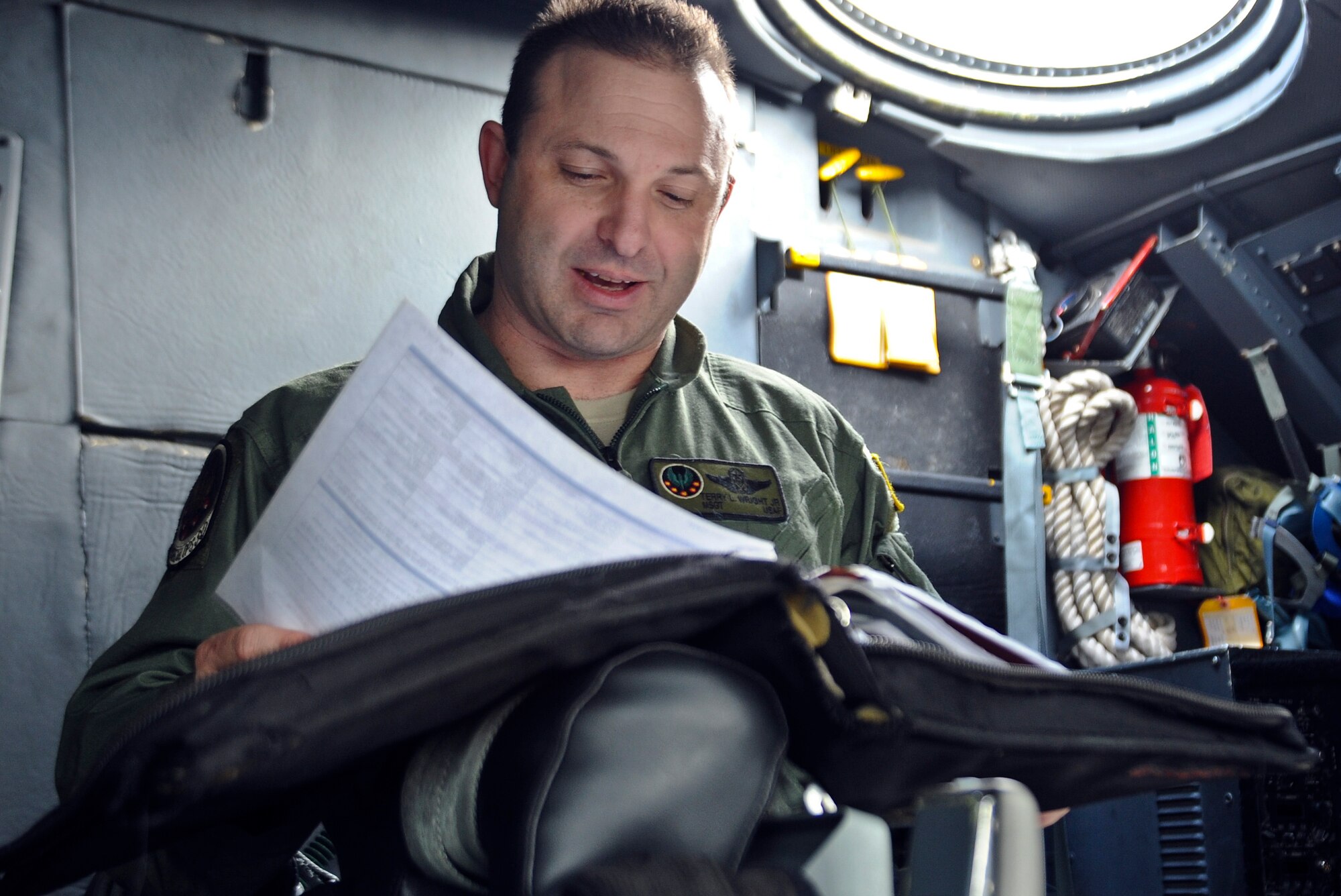 Master Sgt. Terry Wright, 15th Special Operations Squadron loadmaster, reads a flight manual on the flightline at Hurlburt Field, Fla., Feb. 19, 2014. (U.S. Air Force photo/Senior Airman Michelle Vickers)