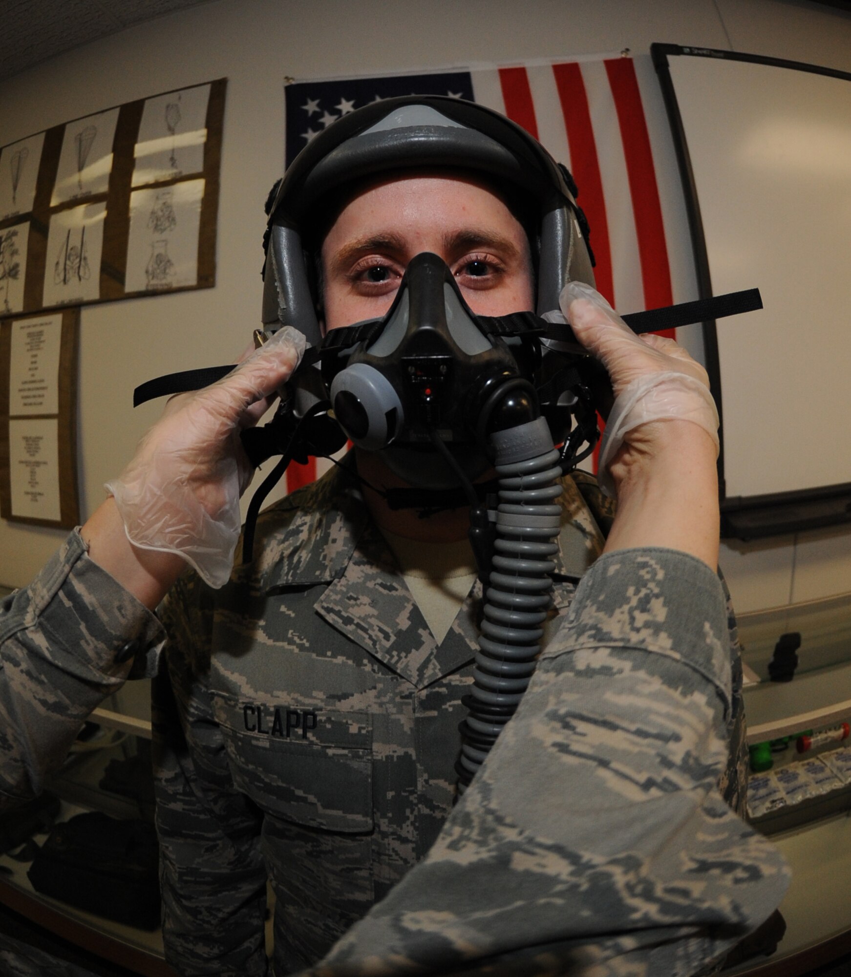 Airman First Class Adam Clapp, 509th Operations Support Squadron aircrew flight equipment technician gets a MBU-20/P soft shell mask fitted to his face at Whiteman Air Force Base Mo., Feb. 18, 2014. The AFE technicians inspect the pilots safety gear before each flight and after each flight as well as 30-day inspections. (U.S. Air Force photo by Airman 1st Class Joel Pfiseiter/Released)