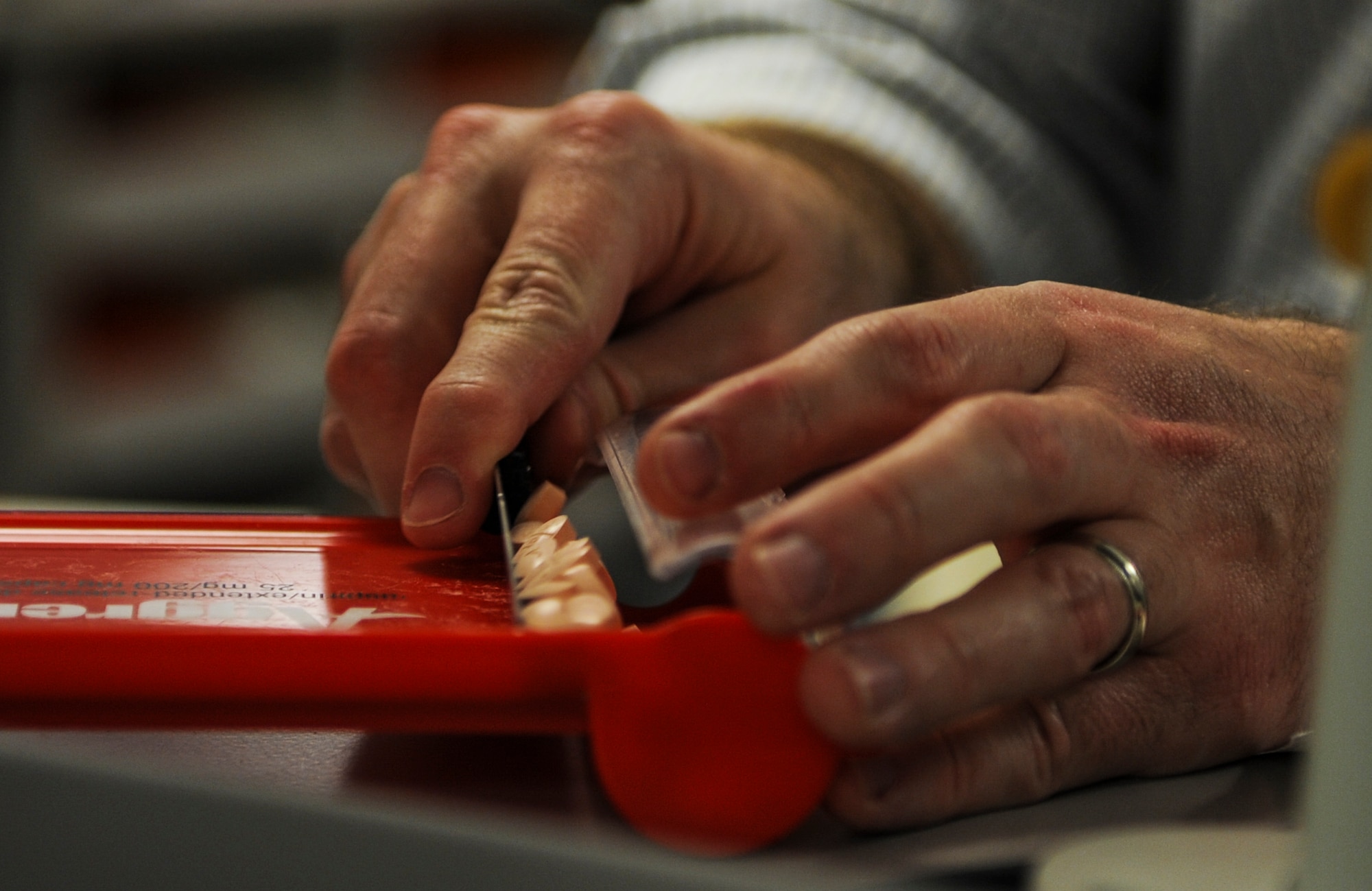 A pharmacist counts out medication on Moody Air Force Base, Ga., Feb. 25, 2014. Specific medications are counted out by hand to guarantee that patients are receiving the correct amount. (U.S. Air Force photo by Airman 1st Class Alexis Millican/Released)