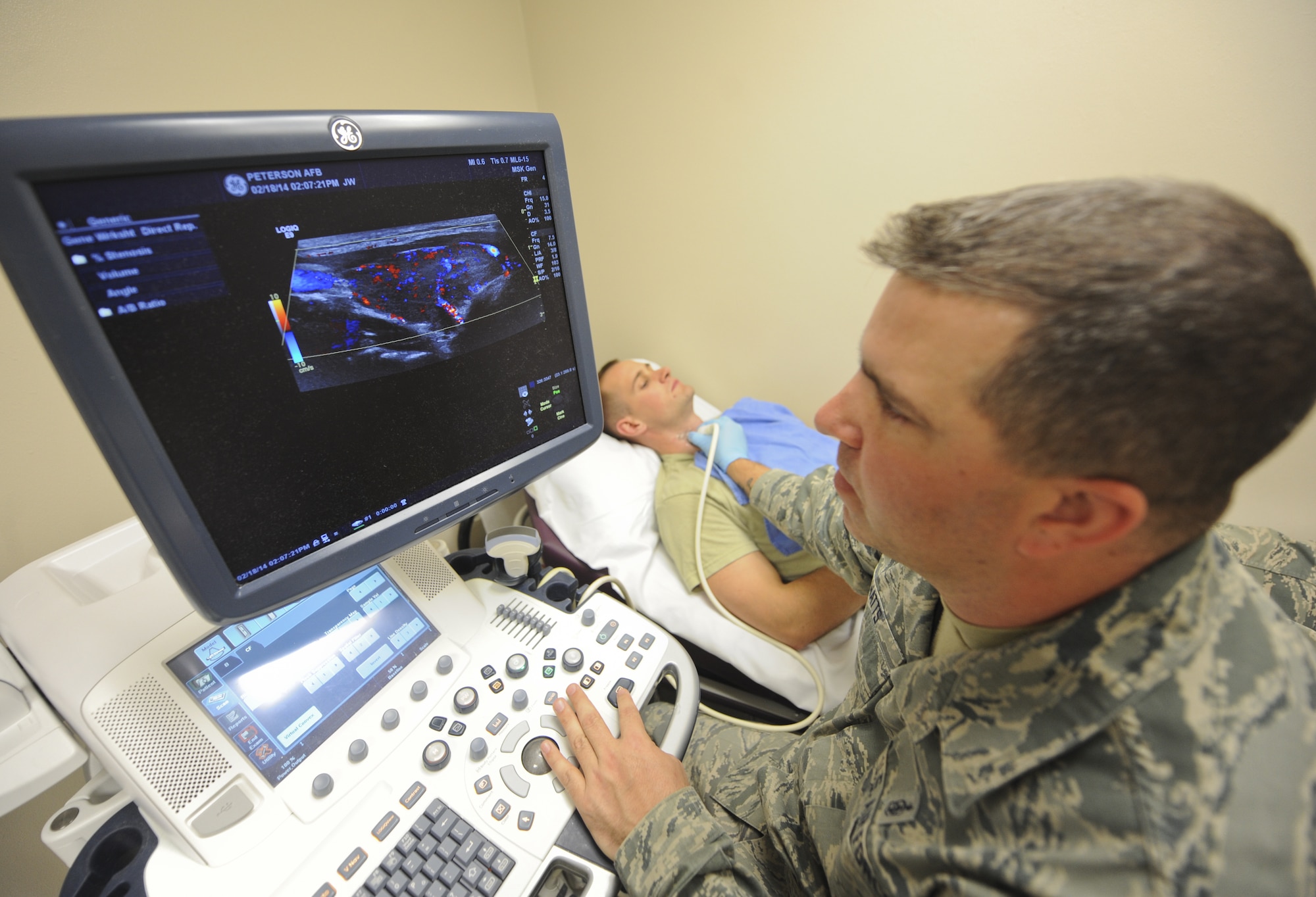 Tech. Sgt. Jerry Watts Jr., 21st Medical Support Squadron NCO in charge of diagnostic imaging, uses an ultrasound machine to check the thyroid of Senior Airman Andrew Bull during training at the 21st Medical Group clinic Feb. 18. Watts is currently the only qualified sonographer with the 21st MDSS performing on average 10 sonograms a day. (U.S. Air Force photo/Staff Sgt. Jacob Morgan)