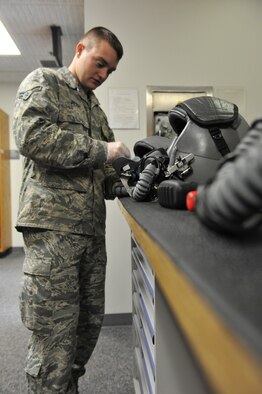Airman 1st Class Brandon Perry, 509th Operations Support Squadron aircrew flight equipment technician, sanitizes an MBU-20/P soft shell mask. AFE technicians clean the insides of the masks to ensure there are no contaminants, debris or germs in the mask. (U.S. Air Force photo by Airman 1st Class Joel Pfiester/Released)