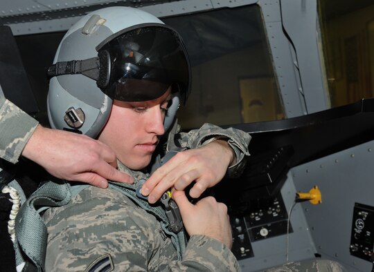 Airman 1st Class Adam Clapp, 509th Operations Support Squadron aircrew flight equipment technician, inspects the harnesses on a back automatic-22 parachute inside a B-2 ground egress simulator. The egress simulator is used to train pilots 
how to get out of the aircraft in an emergency situation on the runway. (U.S. Air Force photo by Airman 1st Class Joel Pfiester/Released)