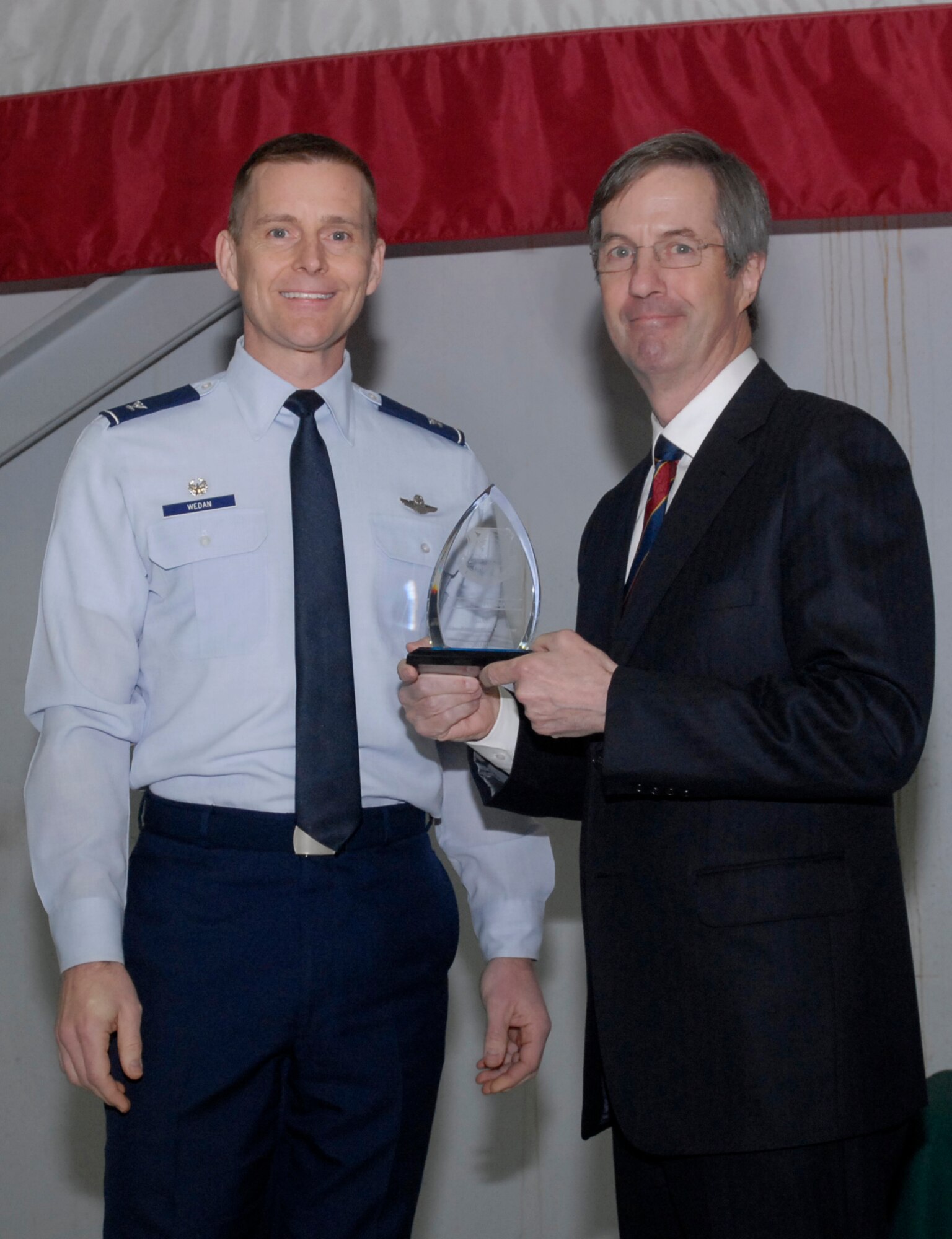 Oregon Air National Guard Col. Rick Wedan, 142nd Fighter Wing Commander and Mr. Bill Wyatt Executive Director for the Port of Portland, pause for a photograph with the Award for Oregon Air National Guard Employer of the Year 2013, during the ceremony to honor the Port of Portland, held at the Portland Air National Guard Base, Ore., Feb. 20, 2014. (Air National Guard photo by Tech. Sgt. John Hughel, 142nd Fighter Wing Public Affairs/Released)