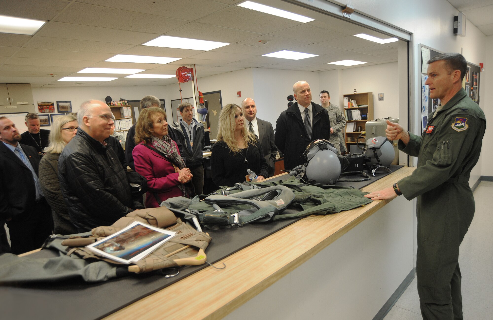 Oregon Air National Guard Col. Rick Wedan, 142nd Fighter Wing Commander, describes some of the equipment used by fighter pilots, to staff members from the Port of Portland, during a tour of the Portland Air National Guard Base, Ore., Feb. 20, 2014. The Port of Portland was selected as the Oregon Air National Guard Employer of the Year for 2013 as was honored in a ceremony earlier in the day. (Air National Guard photo by Tech. Sgt. John Hughel, 142nd Fighter Wing Public Affairs/Released)