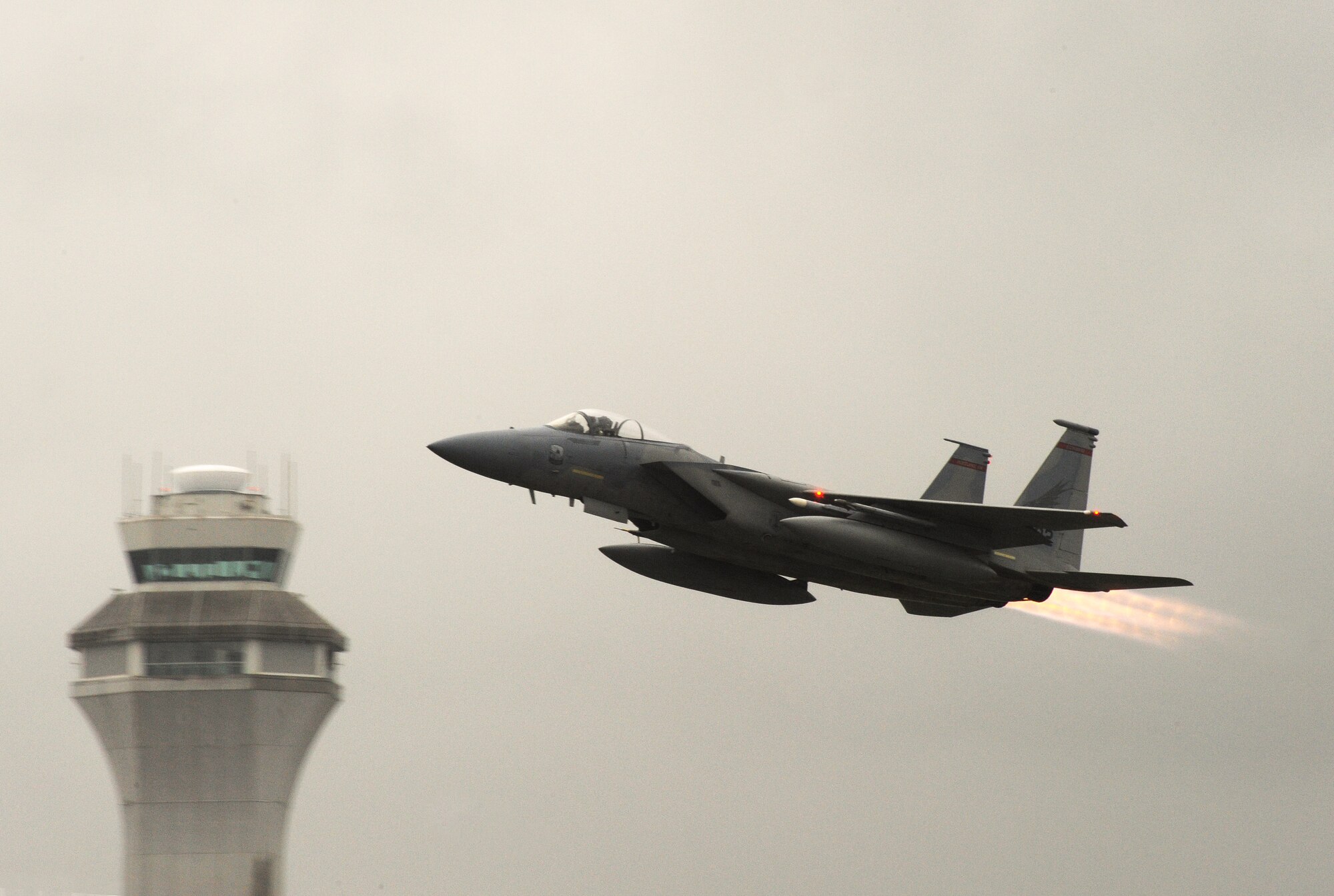 An F-15 Eagle from the 142nd Fighter Wing takes off from the Portland Air National Guard Base, Ore., with the Port of Portland tower in the background, Feb. 20, 2014. The Port of Portland was selected as the Oregon Air National Guard Employer of the Year for 2013 and was honored during a ceremony held at the Air Base earlier in the day. (Air National Guard photo by Tech. Sgt. John Hughel, 142nd Fighter Wing Public Affairs/Released)