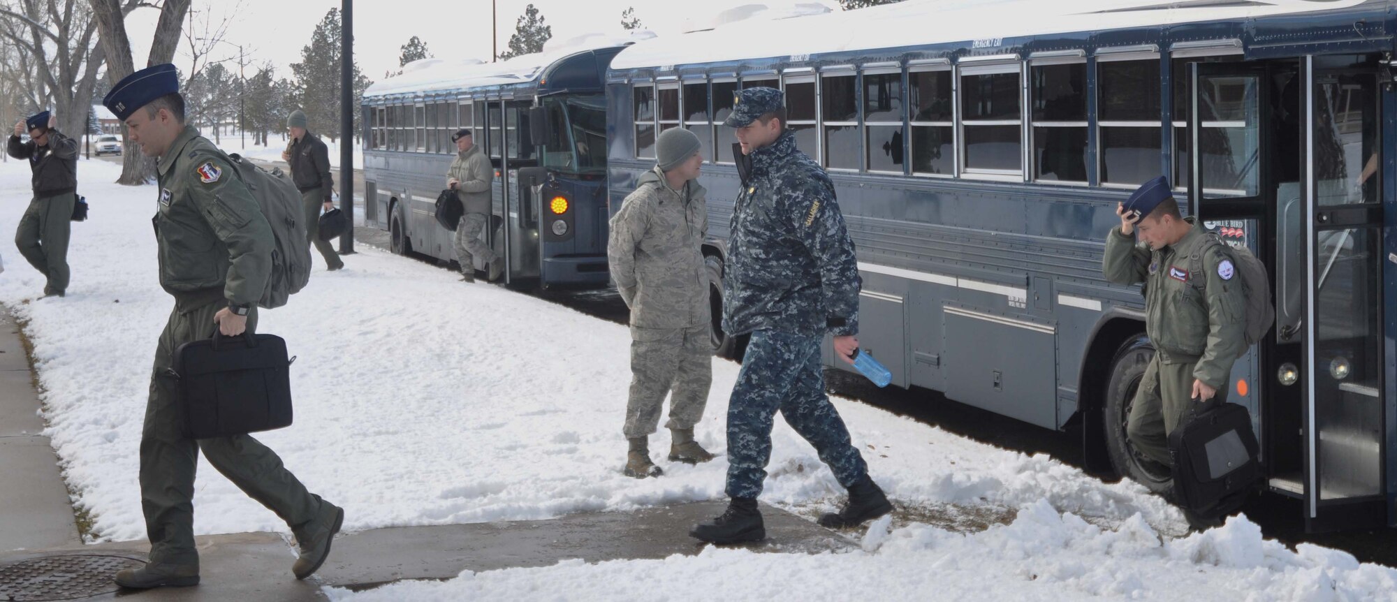 140223-F-GZ967-007 Members of the Force Improvement Program team step off the busses after arriving at F.E. Warren Feb. 23. Warren is the final stop on a tour of Air Force Global Strike Command missile bases and will host the presentation of information from the FIP team to Lt. Gen. Stephen Wilson, AFGSC commander. (U.S. Air Force photo by Airman 1st Class Brandon Valle)