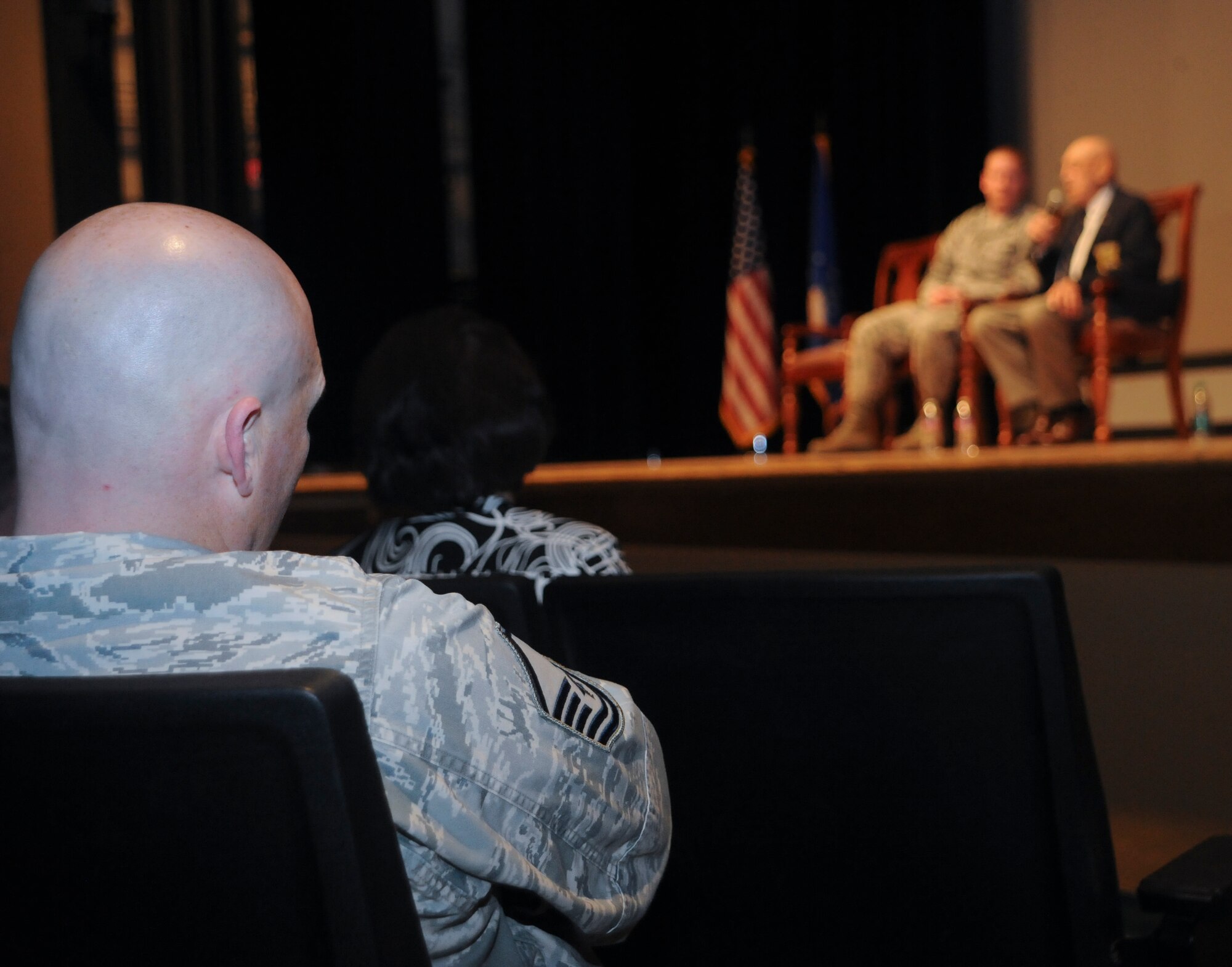 Members of the audience listen to retired U.S. Air Force Lt. Col. Richard “Dick” Cole, a Doolittle Raider, speak at the base theater about the raid at Davis-Monthan Air Force Base, Ariz., Feb. 24, 2014. The Doolittle Raid, April 18, 1942, was the first air raid by the United States on the Japan, in which 16 B-25 bombers and over 80 men participated in during World War II. (U.S. Air Force photo by Senior Airman Sivan Veazie/Released)	
