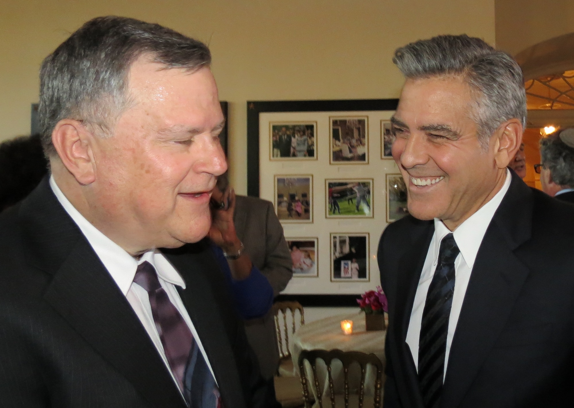 WASHINGTON, D.C. -- Dr. Paul Green, cultural resource specialist for the Air Force Civil Engineer Center's East Installation Support Team at Joint Base Langley-Eustis, Va., chats with George Clooney, actor and director of the film The Monuments Men, at a special White House screening of the movie held Feb. 18. (Courtesy photo)