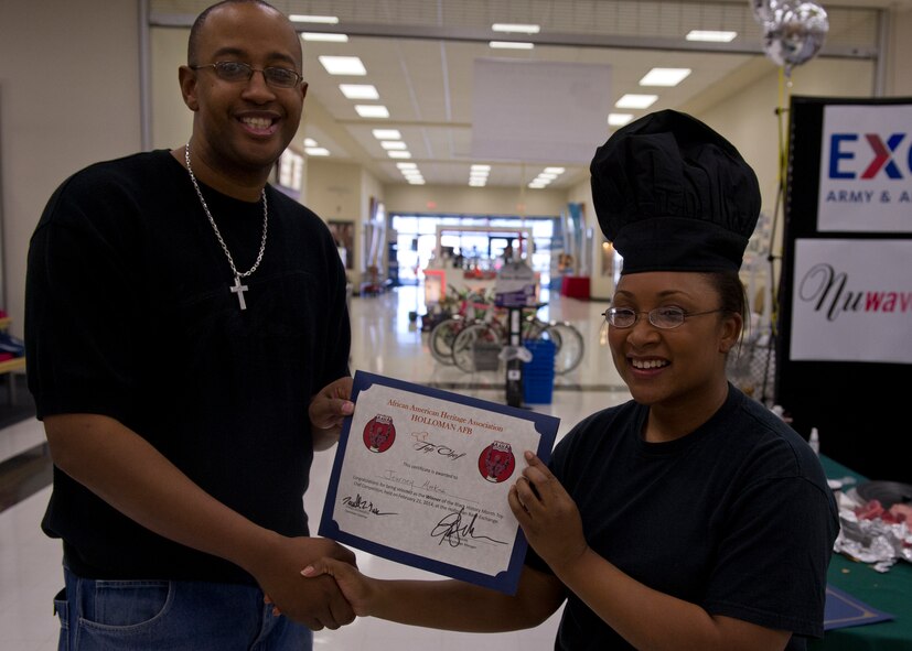 Handan Dvorak and Maj. Jeurney Meekins, 849th Air Maintenance Squadron commander, both finalists in the Holloman Top Chef competition, take a moment to pose while preparing their tables for the competition in the Holloman Air Force Base, N.M., Base Exchange Feb. 21. This was the first ever annual Holloman Top Chef competition held by the base’s African American Heritage committee. (U.S. Air Force photo by Airman 1st Class Chase Cannon/Released)