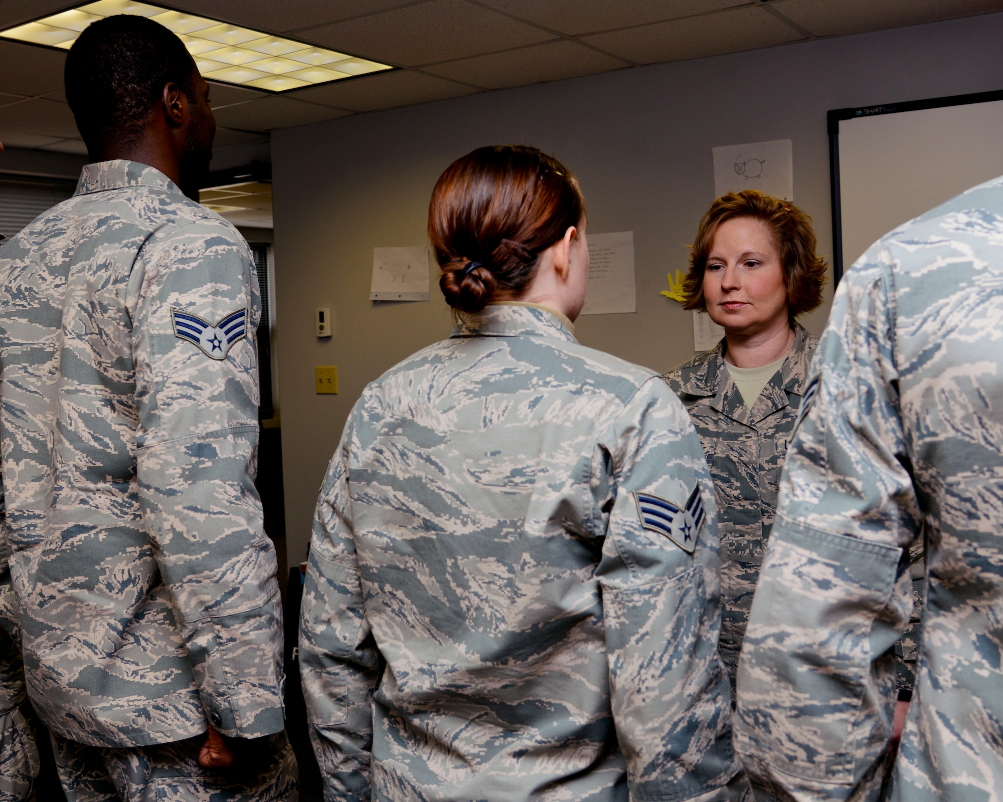 U.S. Air Force Staff Sgt. Aimee Orndorff, 633rd Force Support Squadron Airman Leadership School instructor, inspects students’ uniforms at Langley Air Force Base, Va., Feb. 11, 2014.  ALS is the first professional military education class that enlisted Service members encounter, which teaches and develops them into the leaders of the future. (U.S. Air Force photo by Airman 1st Class Victoria H. Taylor/Released)