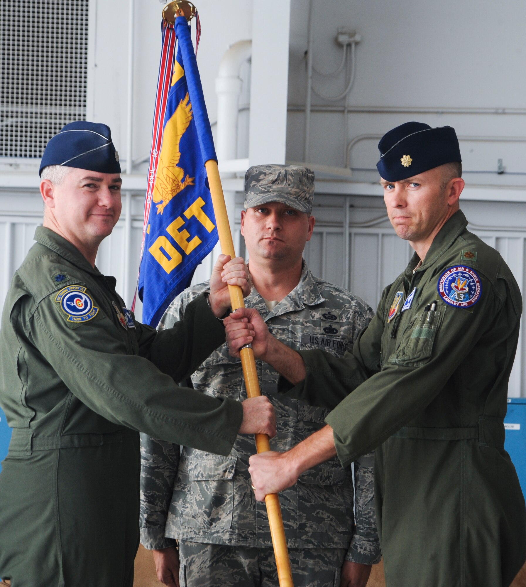 U.S. Air Force Maj. Dennis Hargis, newly appointed commander of the Detachment 3, Air Combat Command Training Support Squadron, accepts the guidon from Lt. Col. Craig Nieman, ACC Training Support Squadron commander, during a change of command ceremony at Davis-Monthan Air Force Base, Ariz., Feb. 24, 2014. The mission of Detachment 3 is to be the Combat Air Force’s focal point for operational training development for both the A-10C and the EC-130H Compass Call weapons systems. (U.S. Air Force photo by Senior Airman Sivan Veazie/Released)
