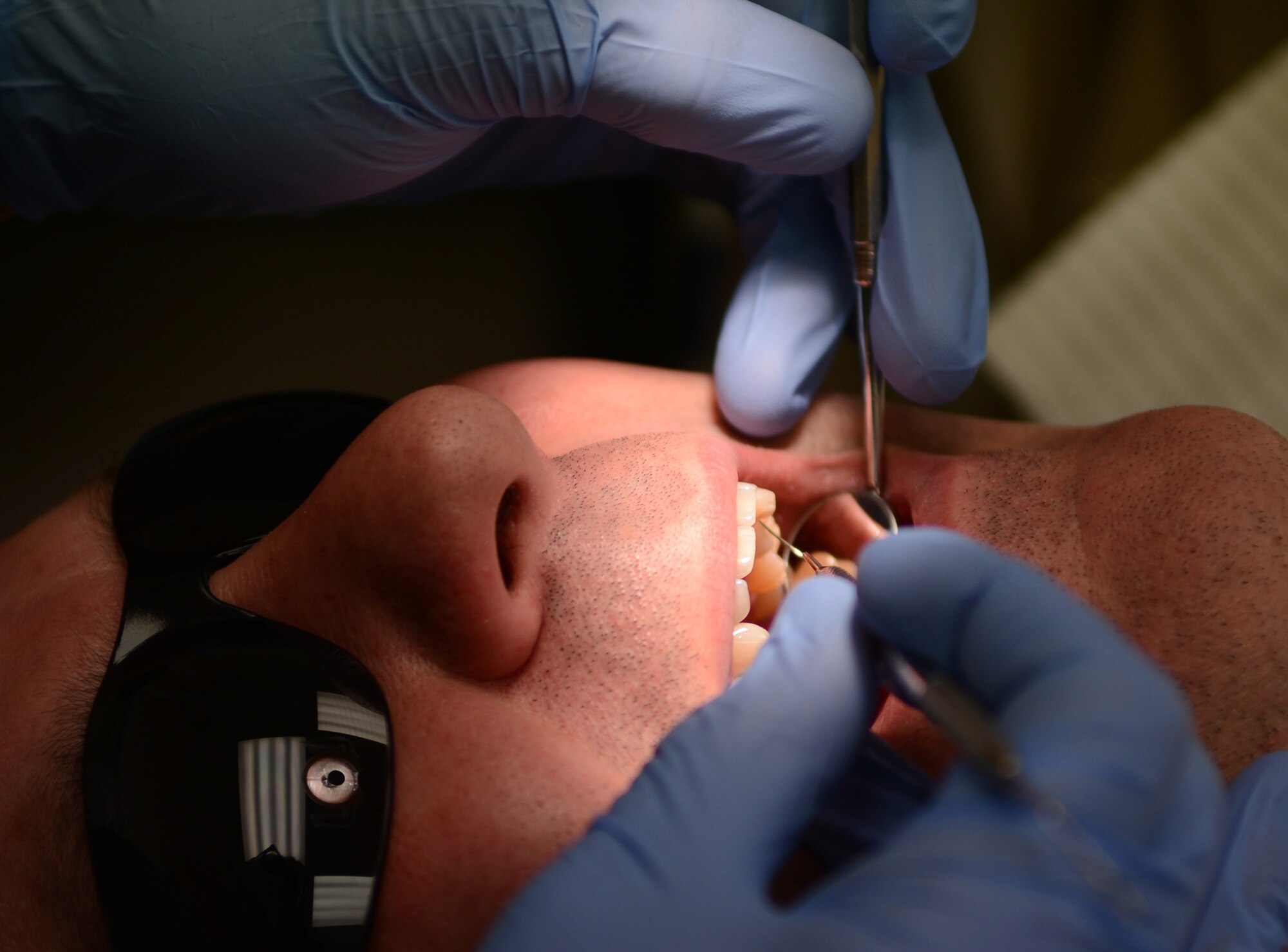 U.S. Air Force Chief Master Sgt. William Markham, 352nd Special Operations Group command chief, receives an annual dental examination from U.S. Air Force Capt. Kurtis Hammack, 48th Dental Squadron general dentist from Oklahoma City, Feb. 25, 2014, at the dental clinic on RAF Mildenhall, England.  It’s important for Airmen to visit the dental clinic regularly to maintain proper dental hygiene. The dental clinic staff provides cleaning, examination and surgical services to Team Mildenhall members. (U.S. Air Force photo by Airman 1st Class Dillon Johnston/Released)