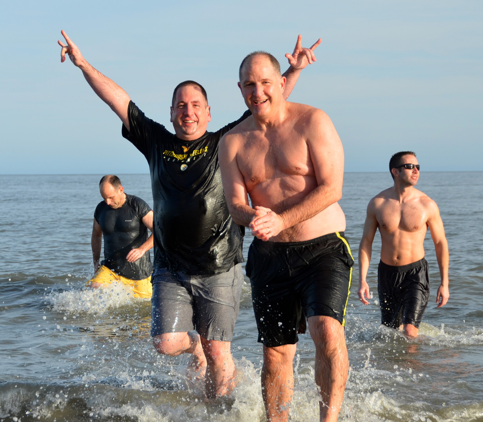 Attendees sprint into the 49 degree ocean as part of a "Polar Plunge" during the Yellow Ribbon Reintegration Program, Hilton Head, S.C., February 22, 2014. (U.S. Air Force photo/SSgt. Kelly Goonan)