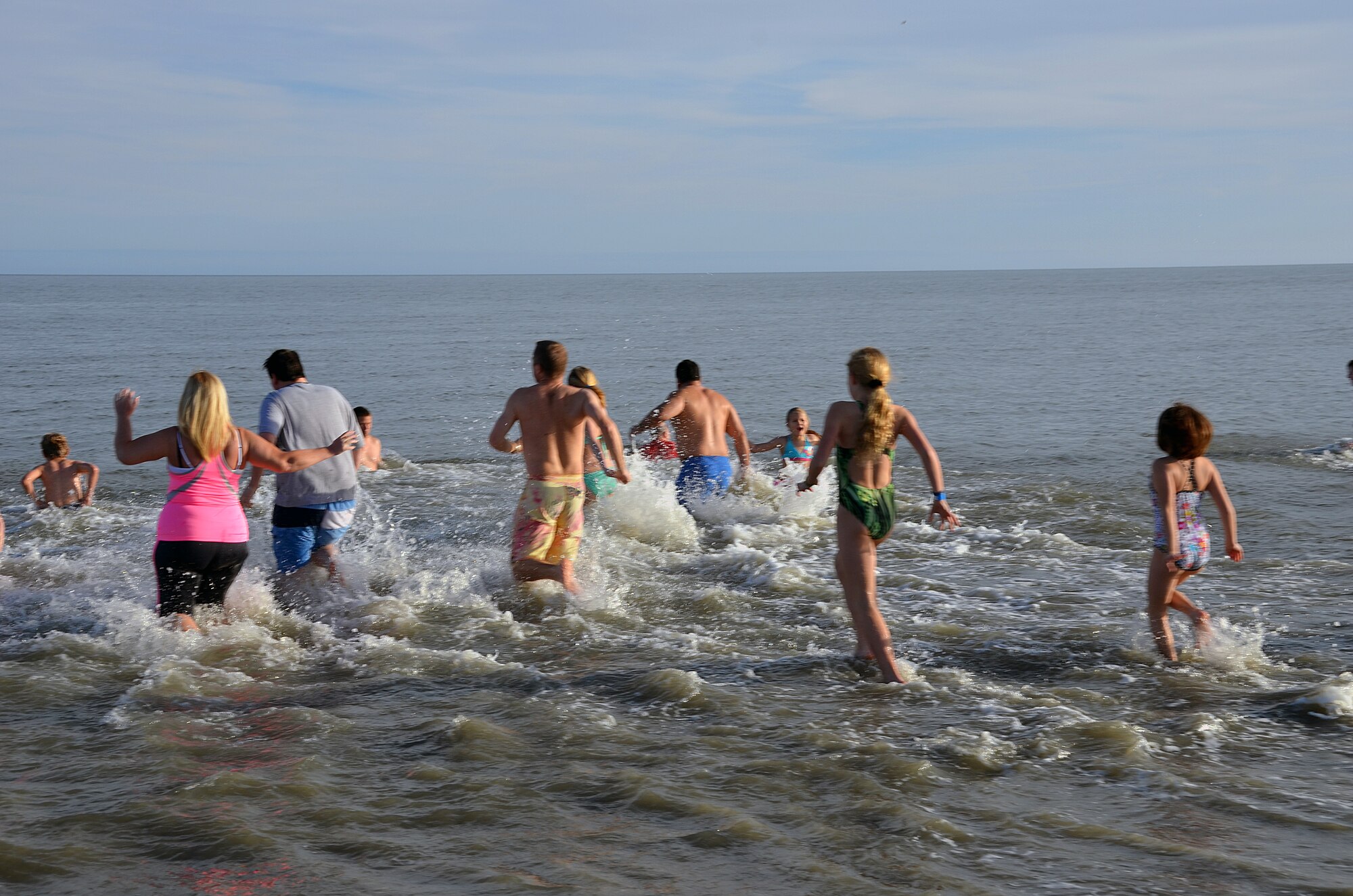 Attendees sprint into the 49 degree ocean as part of a "Polar Plunge" during the Yellow Ribbon Reintegration Program, Hilton Head, S.C., February 22, 2014 as part of a demonstration. (U.S. Air Force photo/SSgt. Kelly Goonan)