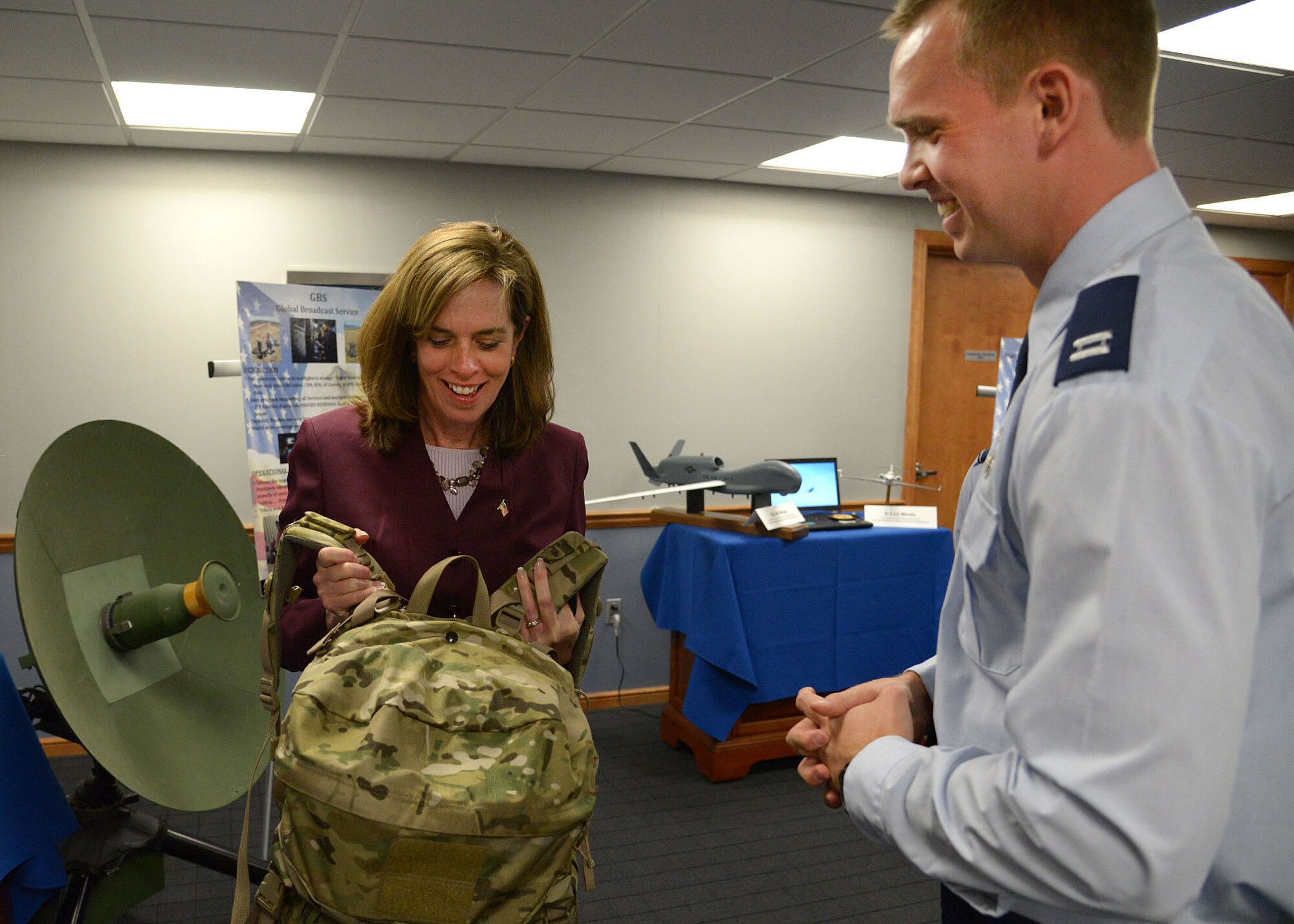 HANSCOM AIR FORCE BASE, Mass. -- U.S. Representative Katherine Clark is shown the Rucksack Portable Receive Suite by Capt. Matthew D. Holland, C3I and Networks Directorate Global Broadcast Service Division deputy program manager, during her first visit here Feb. 24. Clark learned about the important work being done at Hanscom and received an Air Force Life Cycle Management Center mission overview, technology demonstrations and a windshield tour of the base. (U.S. Air Force photo by Mark Wyatt)