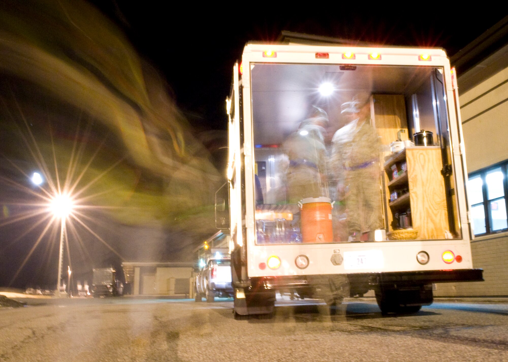 Members of the Dover Chiefs Group wait for Airmen in the back of the Holy Roller Feb. 19, 2014, at Dover Air Force Base, Del. The Chiefs Group passed out more than 50 quarts of chili around base. (U.S. Air Force photo/Airman 1st Class Zachary Cacicia) 