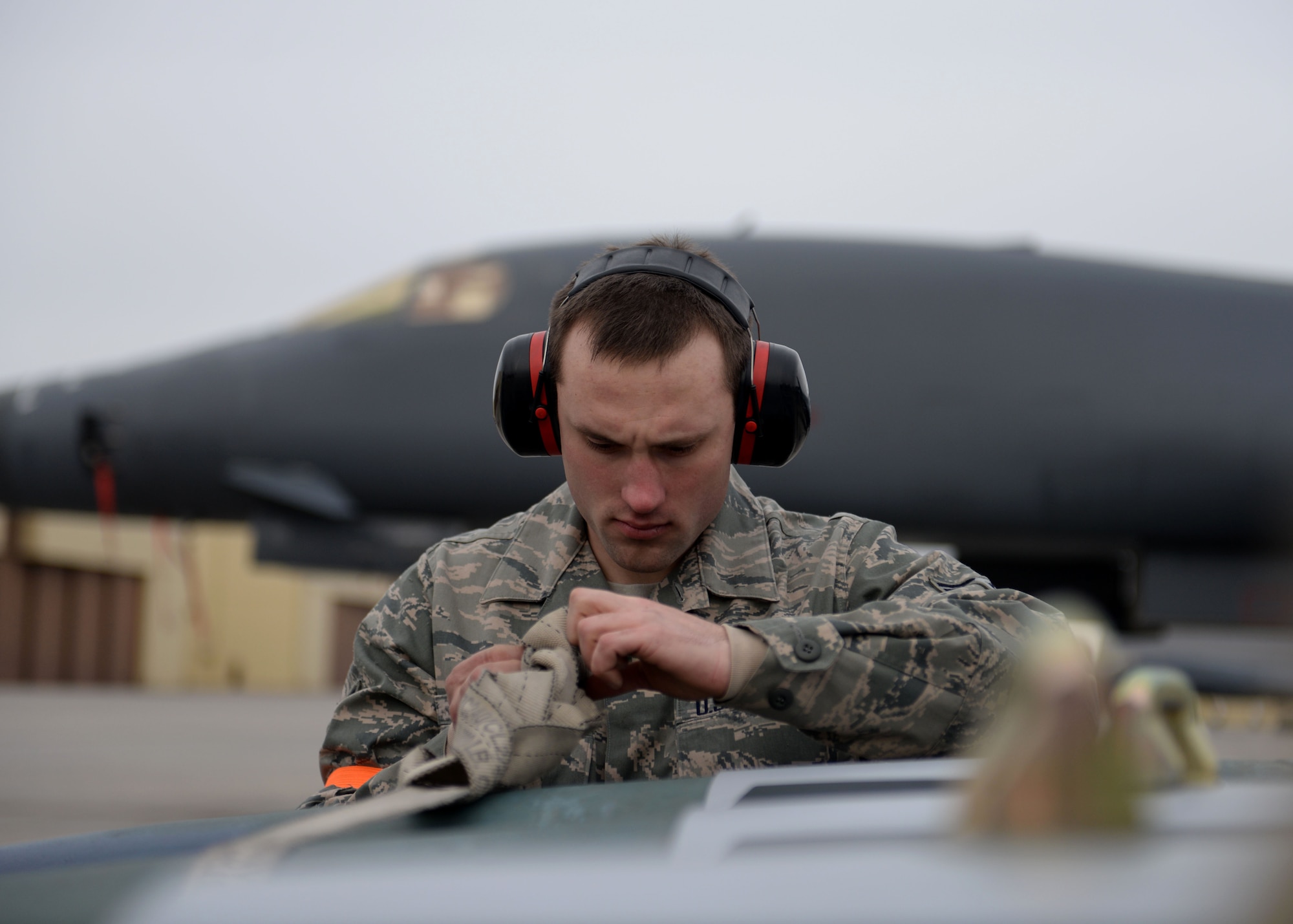Airman 1st Class Tyler Taffner, 28th Aircraft Maintenance Squadron weapons load crew member secures a GBU-31 to a munitions trailer during the Combat Hammer exercise at Ellsworth Air Force Base, S.D., Feb. 14, 2014. Each day of the exercise, two B-1 bombers were loaded and flown by aircrews from the 34th Bomb Squadron to the Eglin Test and Training Complex Range at Eglin AFB, Fla., to test the effectiveness, maintainability, suitability and accuracy of these precision guided munitions. (U.S. Air Force photo by Airman 1st Class Rebecca Imwalle/ Released)