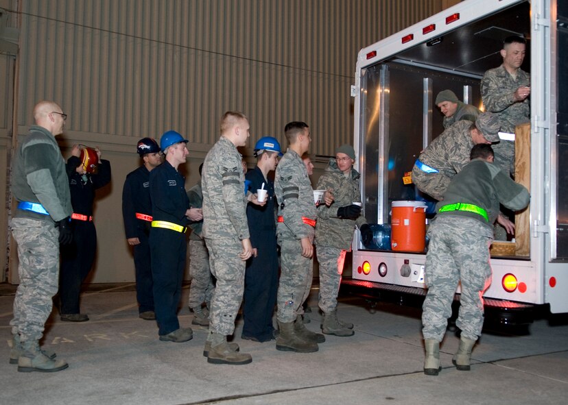 Airmen from the 436th Aircraft Maintenance Squadron wait in line behind the Holy Roller van Feb. 19, 2014, at Dover Air Force Base, Del. The Chiefs Group and chaplains provided chili and hot chocolate to an estimated 300 working Airmen. (U.S. Air Force photo/Airman 1st Class Zachary Cacicia) 