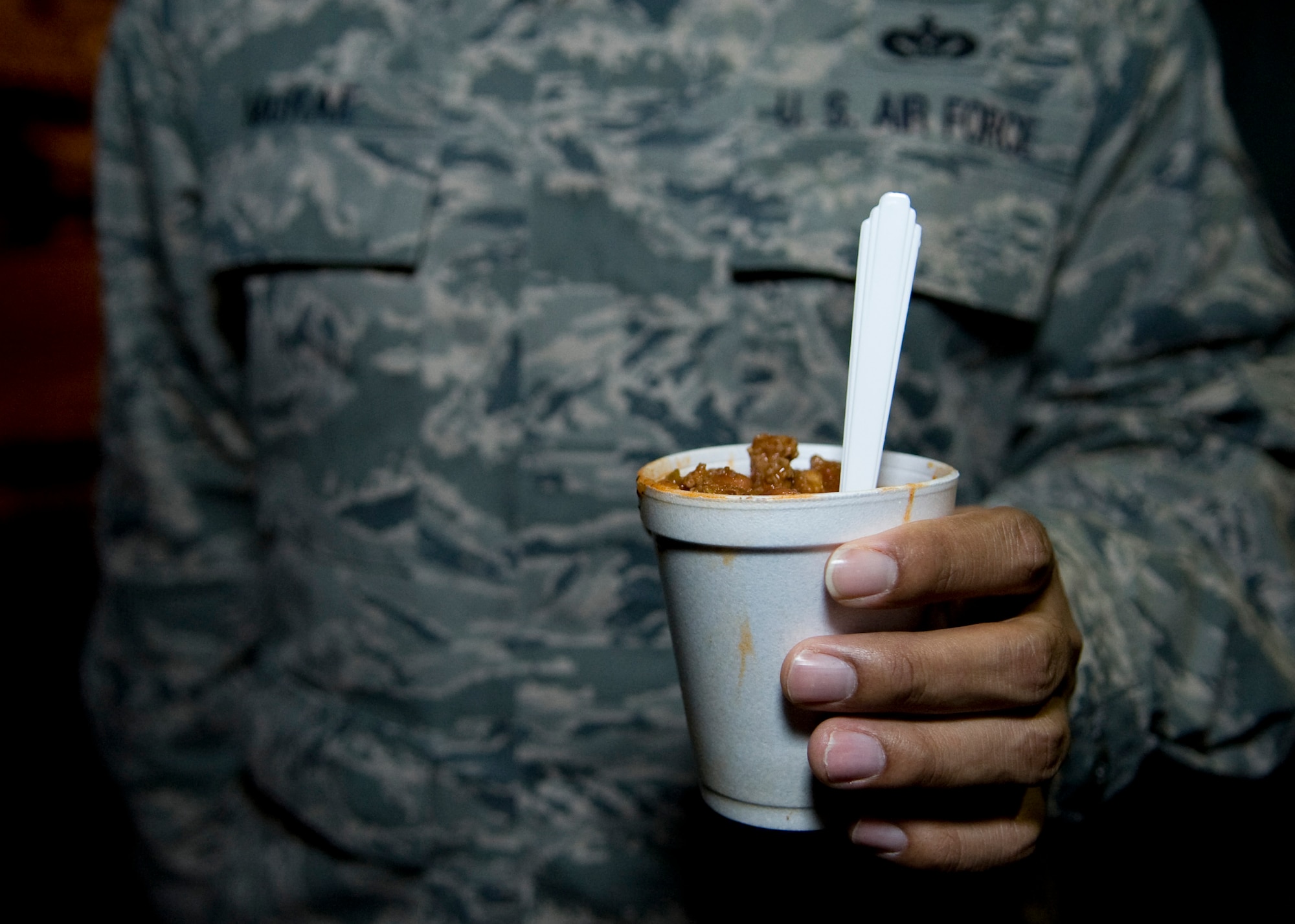 Tech. Sgt. Aaron McRae, 736th Aircraft Maintenance Squadron hydraulics craftsman, holds a cup of chili provided to him by the Dover Chiefs Group Feb. 19, 2014, at Dover Air Force Base, Del. Using the Holy Roller van, the Dover Chiefs Group partnered with DAFB’s chaplains to provide chili, hot chocolate, and other snacks to Airmen. (U.S. Air Force photo/Airman 1st Class Zachary Cacicia)