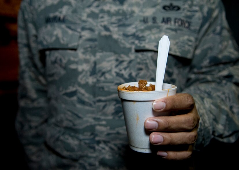Tech. Sgt. Aaron McRae, 736th Aircraft Maintenance Squadron hydraulics craftsman, holds a cup of chili provided to him by the Dover Chiefs Group Feb. 19, 2014, at Dover Air Force Base, Del. Using the Holy Roller van, the Dover Chiefs Group partnered with DAFB’s chaplains to provide chili, hot chocolate, and other snacks to Airmen. (U.S. Air Force photo/Airman 1st Class Zachary Cacicia)