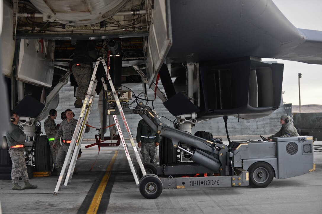 Weapons load crew Airmen assigned to the 28th Aircraft Maintenance Squadron load GBU-31 Laser Joint Direct Attack Munitions onto a B-1 bomber during the Combat Hammer exercise at Ellsworth Air Force Base, S.D., Feb. 14, 2014. Aircrews from the 34th Bomb Squadron tested their ability to employ GBU-31s and GBU-54s against moving targets during Combat Hammer, the Air Force’s air to ground Weapons System Evaluation Program exercise. (U.S. Air Force photo by Senior Airman Zachary Hada/Released)