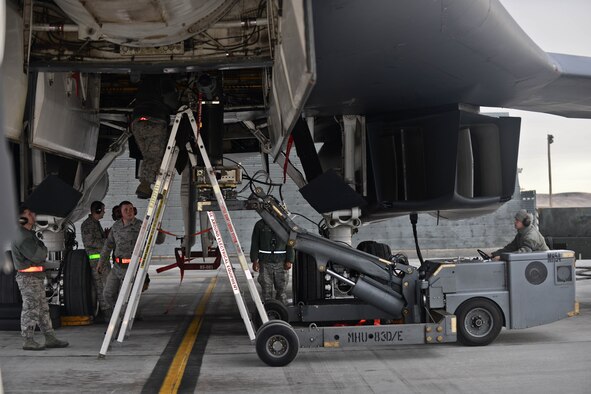 Weapons load crew Airmen assigned to the 28th Aircraft Maintenance Squadron load GBU-31 Laser Joint Direct Attack Munitions onto a B-1 bomber during the Combat Hammer exercise at Ellsworth Air Force Base, S.D., Feb. 14, 2014. Aircrews from the 34th Bomb Squadron tested their ability to employ GBU-31s and GBU-54s against moving targets during Combat Hammer, the Air Force’s air to ground Weapons System Evaluation Program exercise. (U.S. Air Force photo by Senior Airman Zachary Hada/Released)