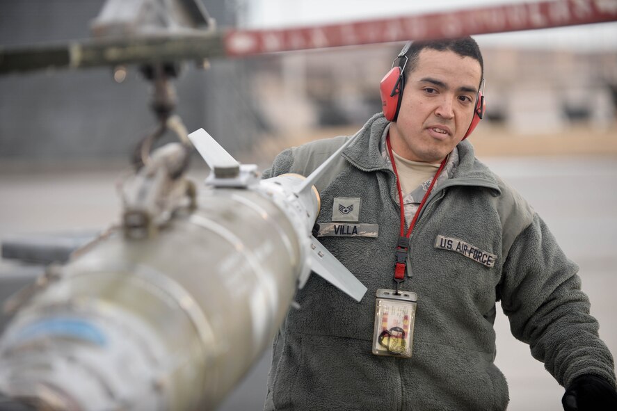 Staff Sgt. Francisco Villa, 28th Aircraft Maintenance Squadron weapons load crew specialist, secures a GBU-31 Laser Joint Direct Attack Munitions during the Combat Hammer exercise at Ellsworth Air Force Base, S.D., Feb. 14, 2014. In addition to providing valuable training for B-1 aircrews and munitions specialists, the exercise also provided maintainers the opportunity to hone their skills loading munitions. (U.S. Air Force photo by Senior Airman Zachary Hada/Released)