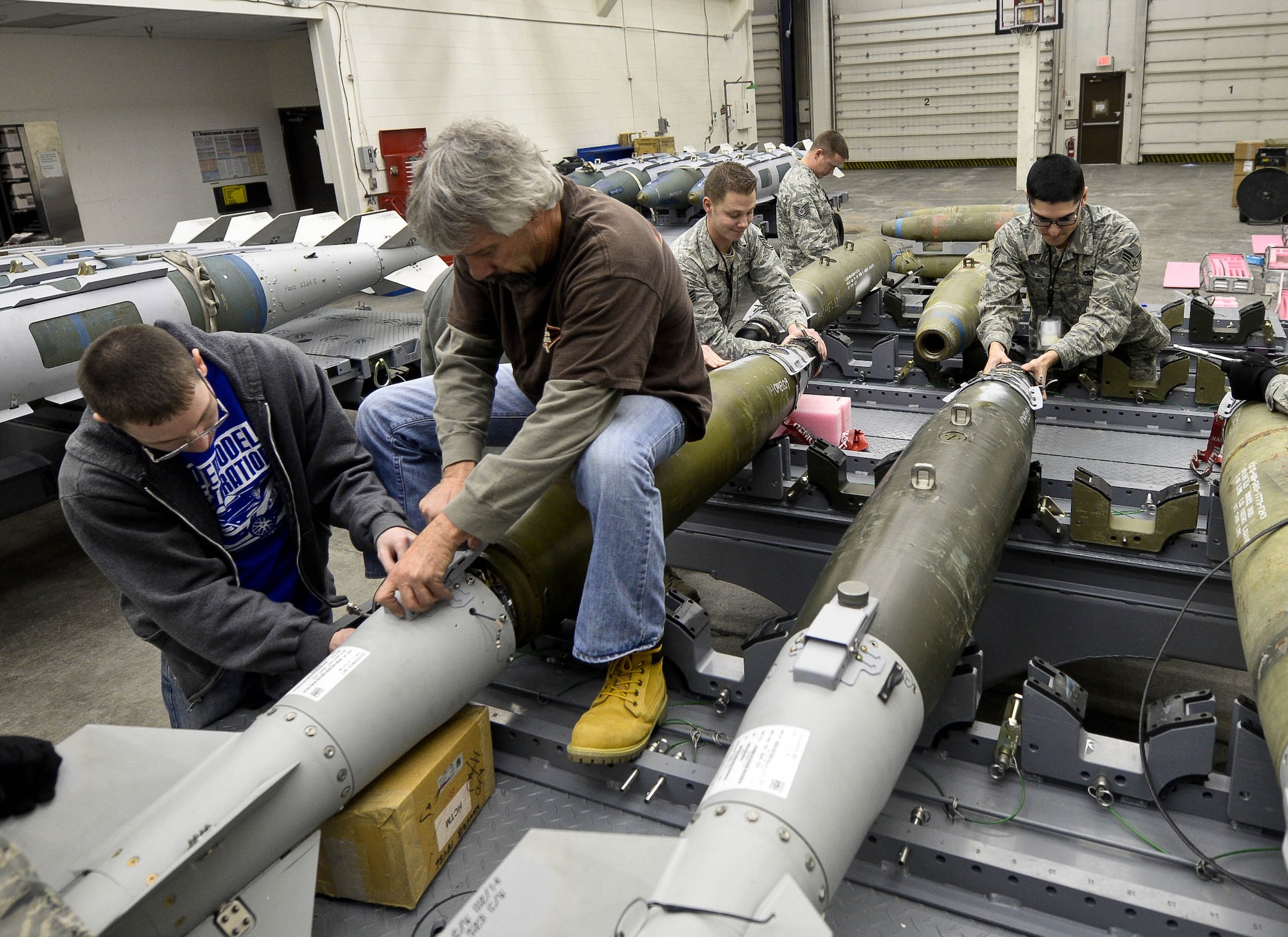 Members of the 28th Munitions Squadron assemble five GBU-31 Laser Joint Direct Attack Munitions during the Combat Hammer exercise at Ellsworth Air Force Base, S.D., Feb. 11, 2014. The squadron inspects and assembles more than 1,707 munitions annually, ensuring Ellsworth B-1 bomber aircrews have the payloads necessary to meet taskings anywhere on the globe. (U.S. Air Force photo by Senior Airman Zachary Hada/Released)