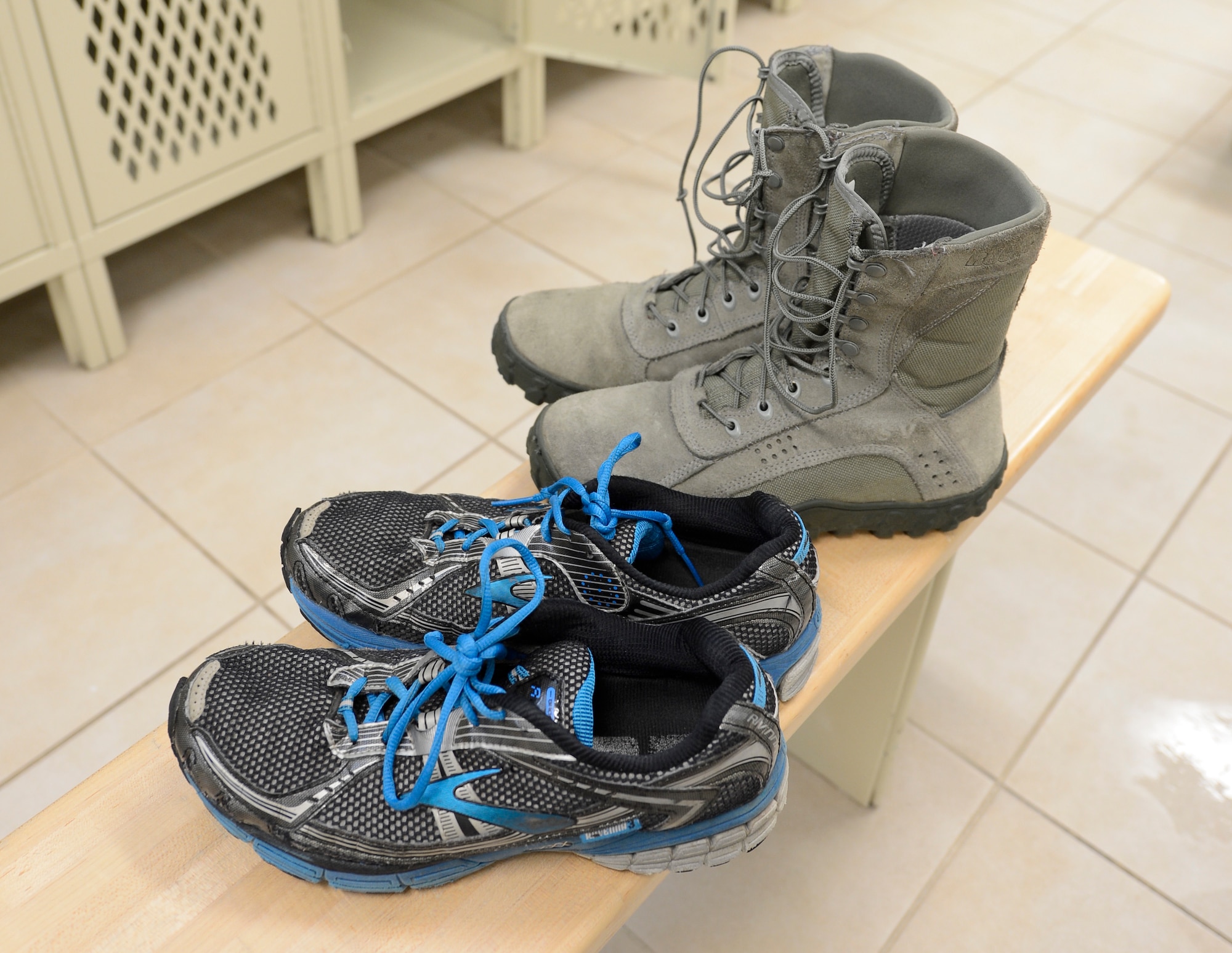 A pair of athletic shoes sit next to a pair of boots inside the Dover Air Force Base fitness center locker room on Feb. 12, 2014. The center has a two-shoe policy to prevent dirt and salt from being tracked onto the fitness equipment and athletic courts which results in damage to equipment, facilities and injuries to personnel. (U.S. Air Force photo/Greg L. Davis) 