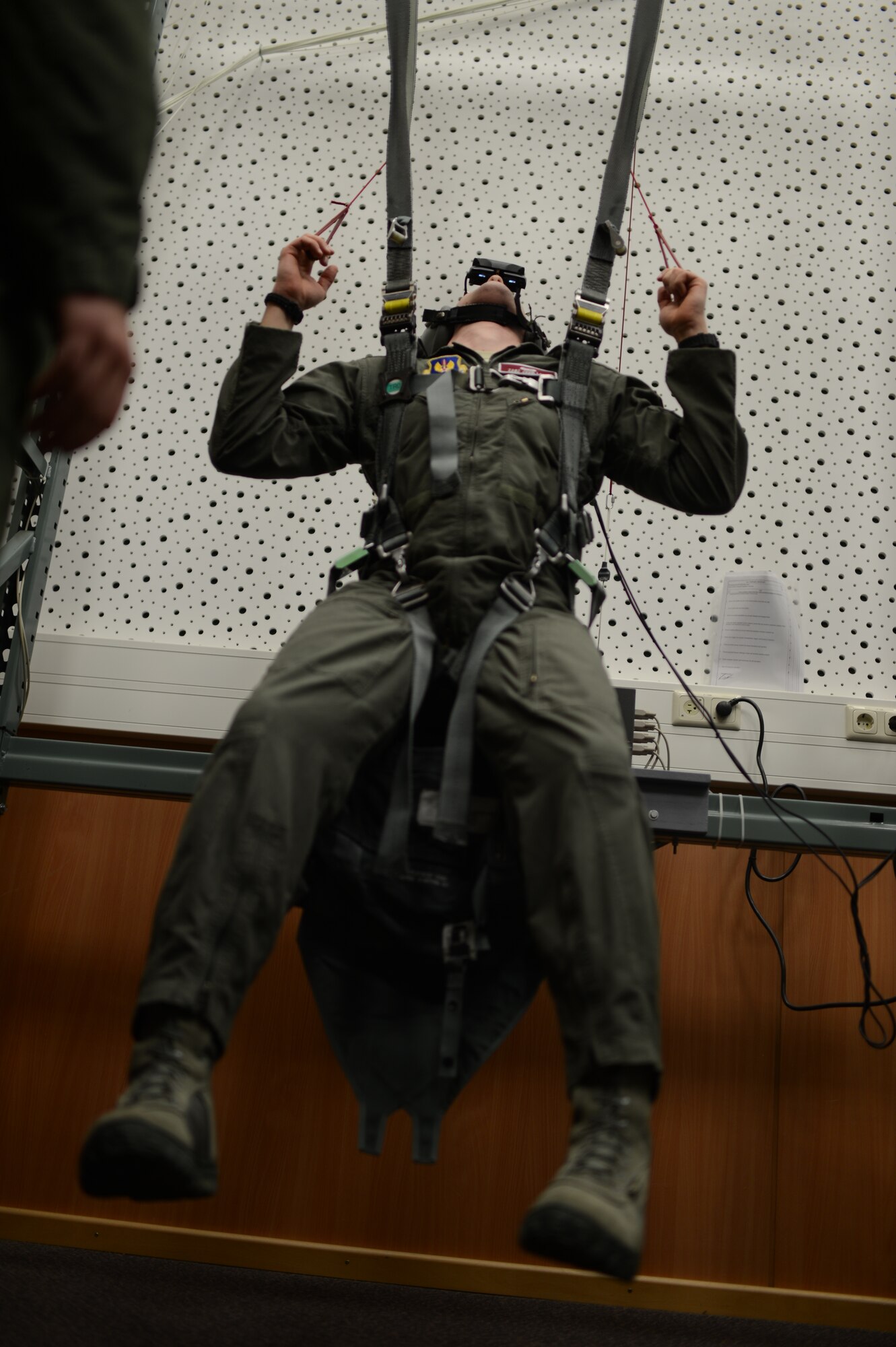 U.S. Air Force Tech. Sgt. John Long, 52nd Operations Support Squadron NCO in charge of weapons and tactics from Clyde Park, Mont., operates a parachute simulator at Spangdahlem Air Base, Germany, Feb. 24, 2014. The simulator mimics canopy control and parachute malfunctions through a heads-up display. (U.S. Air Force photo by Senior Airmen Gustavo Castillo/Released)